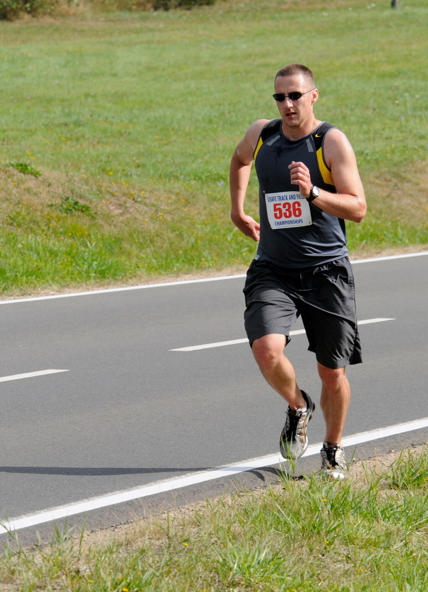 SPANGDAHLEM AIR BASE, Germany – Staff Sgt Brent Murphy, 52nd Equipment Maintenance Squadron, pulls ahead of other 10 kilometer runners on the base perimeter road. The fitness center staff organized simultaneous 10 and 5 K runs Aug. 29 around the perimeter running paths on Spangdahlem. (U.S. Air Force photo/Master Sgt Bill Gomez)