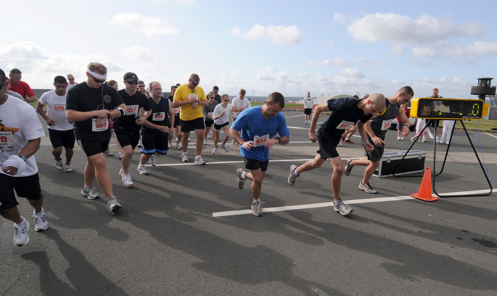 SPANGDAHLEM AIR BASE, Germany – Fitness center staff members sound the bullhorn to start the race for approximately 40 runners participating in organized 10 and 5 kilometer runs Aug 29.  The fitness center staff organized simultaneous 10 and 5K runs around the perimeter running paths on Spangdahlem. (U.S. Air Force photo/Master Sgt Bill Gomez)