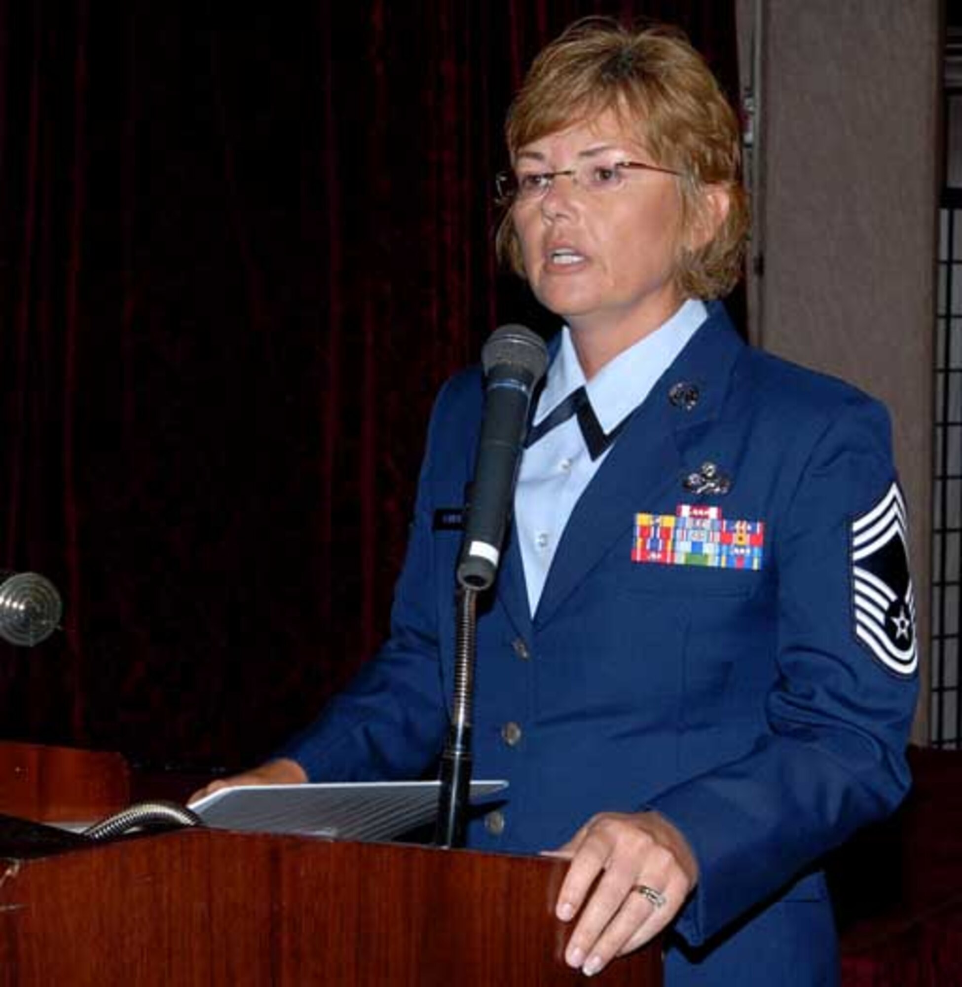 Chief Master Sgt. Victoria Gamble, 18th Maintenance Group superintendent and the guest speaker at the Women's Equality Day luncheon, held Aug. 26 at the Rocker NCO Club, addresses the crowd. (U.S. Air Force Photo/Junko Kinjo)
