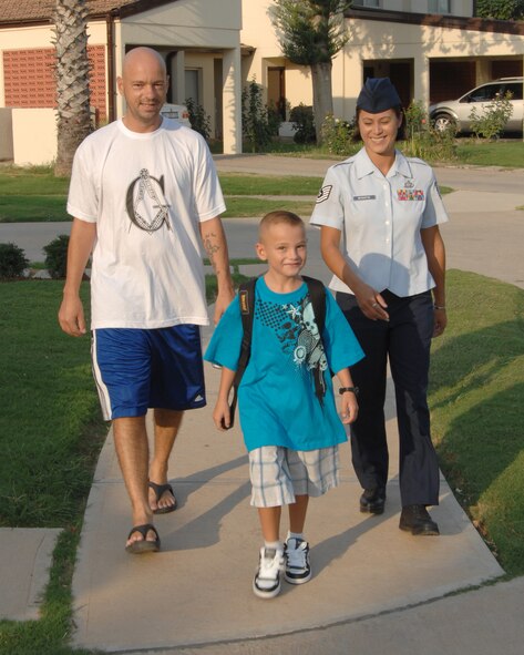 Tech. Sgt. Sascha Harmon, 39th Communications Squadron, and wife Tech. Sgt. Rose McGuffin, American Forces Network, Detachment 7, walk their son, Devin, to school for his first day of second grade at Incirlik Unit School Monday, Aug. 31, 2009, Incirlik Air Base, Turkey. Col. Eric Beene, the 39th Air Base Wing commander, rang in the first day of school by sounding a gong along with Incirlik Unit School principal, Terry Greene. (U.S. Air Force photo/Staff Sgt. Lauren Padden)