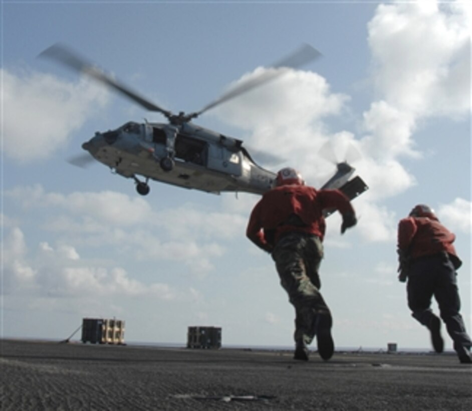 U.S. Navy sailors aboard the aircraft carrier USS Harry S. Truman (CVN 75) prepare to receive supplies from dry cargo-ammunition ship USNS Supply (T-AOE 6) in the Atlantic Ocean on Aug. 27, 2009.  The Truman is underway conducting carrier qualifications.  
