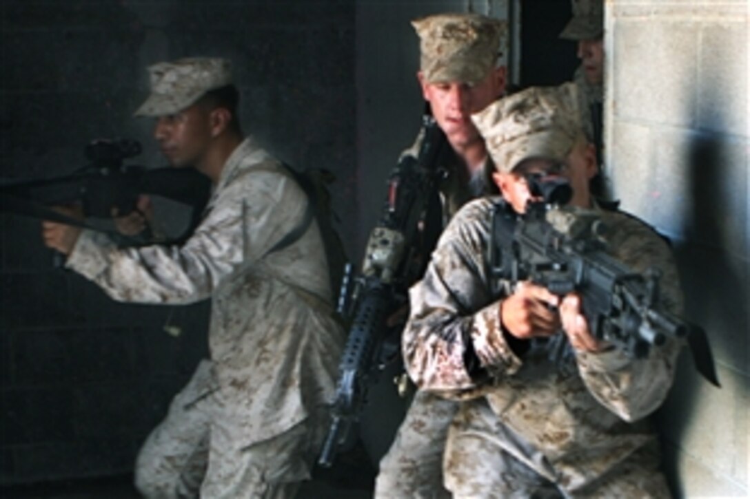 U.S. Marine Lance Cpl. David D. Burt Jr. leads his team down a hallway as they conduct room-clearing exercises at the Military Operations in Urban Terrain facility on Camp Lejeune, N.C., Aug. 17, 2009, during the Heliborne Company Raid Course.