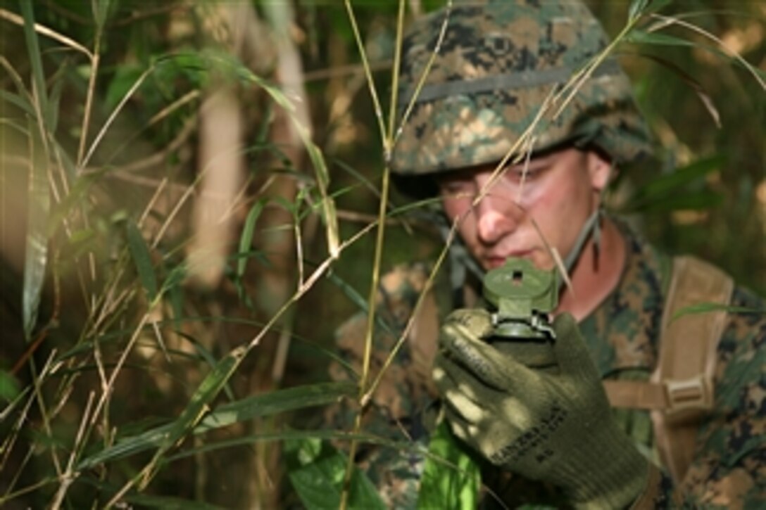 U.S. Marine Corps Lance Cpl. Nathan Sorrentino, with the Provost Marshal's Office, navigates for his patrol at the Jungle Warfare Training Center at Camp Gonsalves, Okinawa, Japan, on Aug. 19, 2009.  The Jungle Warfare Training Center shows service members how to become effective war fighters in a jungle environment by teaching them land navigation, small unit leadership, patrolling and obstacle maneuvering.  