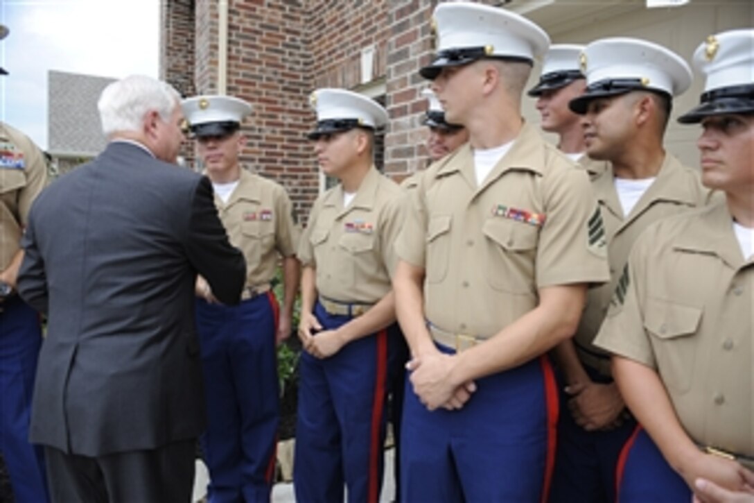 Secretary of Defense Robert M. Gates meets with Marines outside the home of retired Capt. Dan Moran, U.S. Marine Corps, in Cypress, Texas, on Aug. 31, 2009.  