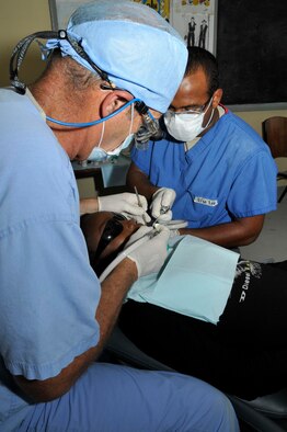 Lt. Col. (Dr.) Darryl Bybee, dentist, 75th Dental Squadron, Hill AFB, and Staff Sgt. Joseph Lee, dental technician from 47th Medical Operations Squadron, Laughlin AFB, performs a filling on Guyanese women Aug. 24, 2009, at the Diamond Secondary School, in Diamond, Guyana. Lt. Col. Bybee spent 31 years in his own private practice before joining the Air Force through direct commission. (U.S. Air Force photo by Airman 1st Class Perry Aston) (Released)