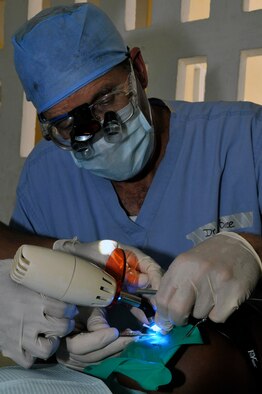 Lt. Col. (Dr.) Darryl Bybee, dentist, 75th Dental Squadron, Hill AFB, performs a filling on Guyanese women Aug. 24, 2009, at the Diamond Secondary School, in Diamond, Guyana. Lt. Col. Bybee spent 31 years in his own private practice before joining the Air Force through direct commission. (U.S. Air Force photo by Airman 1st Class Perry Aston) (Released)