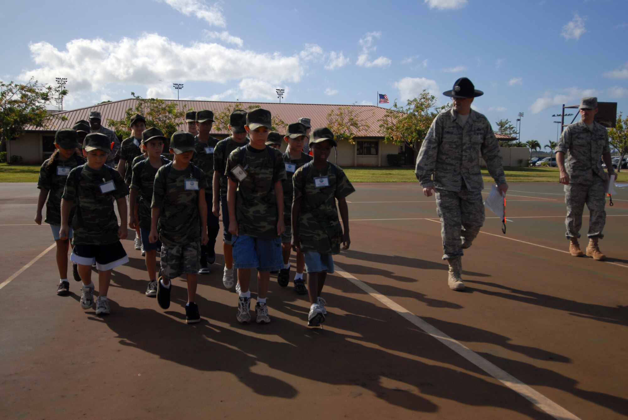 HICKAM AIR FORCE BASE, HAWAII -- Master Sgt. Jody Parker, 8th Intelligence Squadron, teaches kids how to march during the sixth annual Operation Hele On,  Aug. 21. Hele On is a program meant to give children of military members an idea of what goes on during a deployment. During the event, kids learned how to march, were issued mobility bags, and were bussed out to the Hickam flight line to tour a C-17 Globemaster III to simulate a deployment. (U.S. Air Force photo/Senior Airman Gustavo Gonzalez)