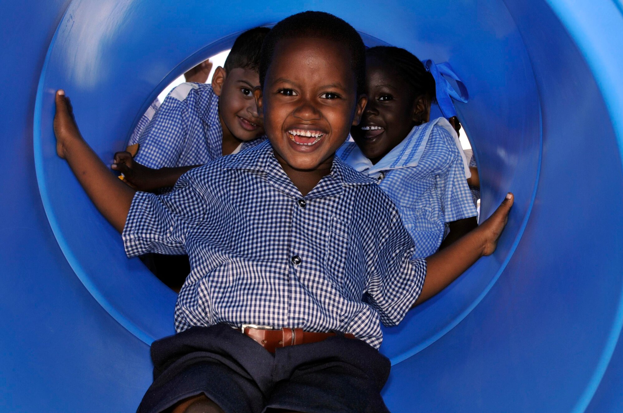 Guyanese children play on a brand new playground Sept. 1, 2009, at the Bel Air Primary, and Nursery Schools Georgetown, Guyana. U.S. Airmen built a playground for the primary school children, and one for the nursery school children, totaling over $ 37,000. (U.S. Air Force photo by Airman 1st Class Perry Aston) (Released)