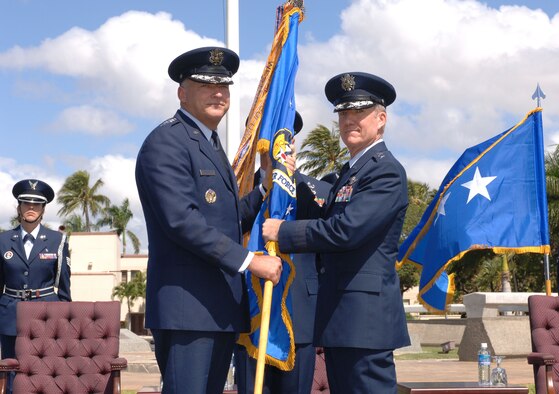 Gen. Gary North, Pacific Air Forces Commander, passes the 13th Air Force unit flag to Lt. Gen. Herbert Carlisle, who assumed command of 13th Air Force during a change of command ceremony at Hickam Air Force Base, Hawaii, Sept. 2. General Carlisle joins 13th Air Force from the Pentagon, where he served as the Director of Legislative Liaison in the Office of the Secretary of the Air Force. (Air Force photo/ Oscar Hernandez) 