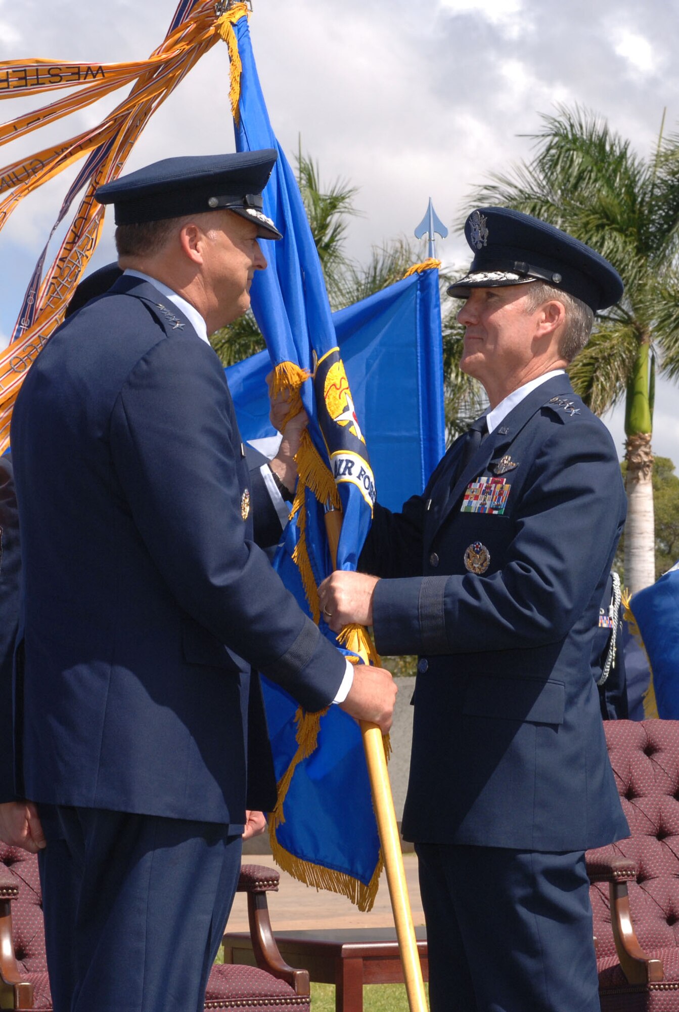 Gen. Gary North, Pacific Air Forces Commander, passes the 13th Air Force unit flag to Lt. Gen. Herbert Carlisle, who assumed command of 13th Air Force during a change of command ceremony at Hickam Air Force Base, Hawaii, Sept. 2. General Carlisle joins 13th Air Force from the Pentagon, where he served as the Director of Legislative Liaison in the Office of the Secretary of the Air Force. (Air Force photo/ Oscar Hernandez) 
