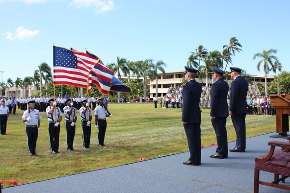 Gen. Gary North, Pacific Air Forces Commander (far right), Lt. Gen. Chip Utterback(center), and Lt. Gen. Herbert Carlisle, salute the U.S. flag during the presentation of the colors at Hickam Air Force Base, Hawaii, Sept. 2. General Utterback relinquished command of 13th Air Force to General Carlisle, who previously served as the Director of Legislative Liaison in the Office of the Secretary of the Air Force at the Pentagon. (Air Force photo/ Tech. Sgt. Kerry Jackson)
