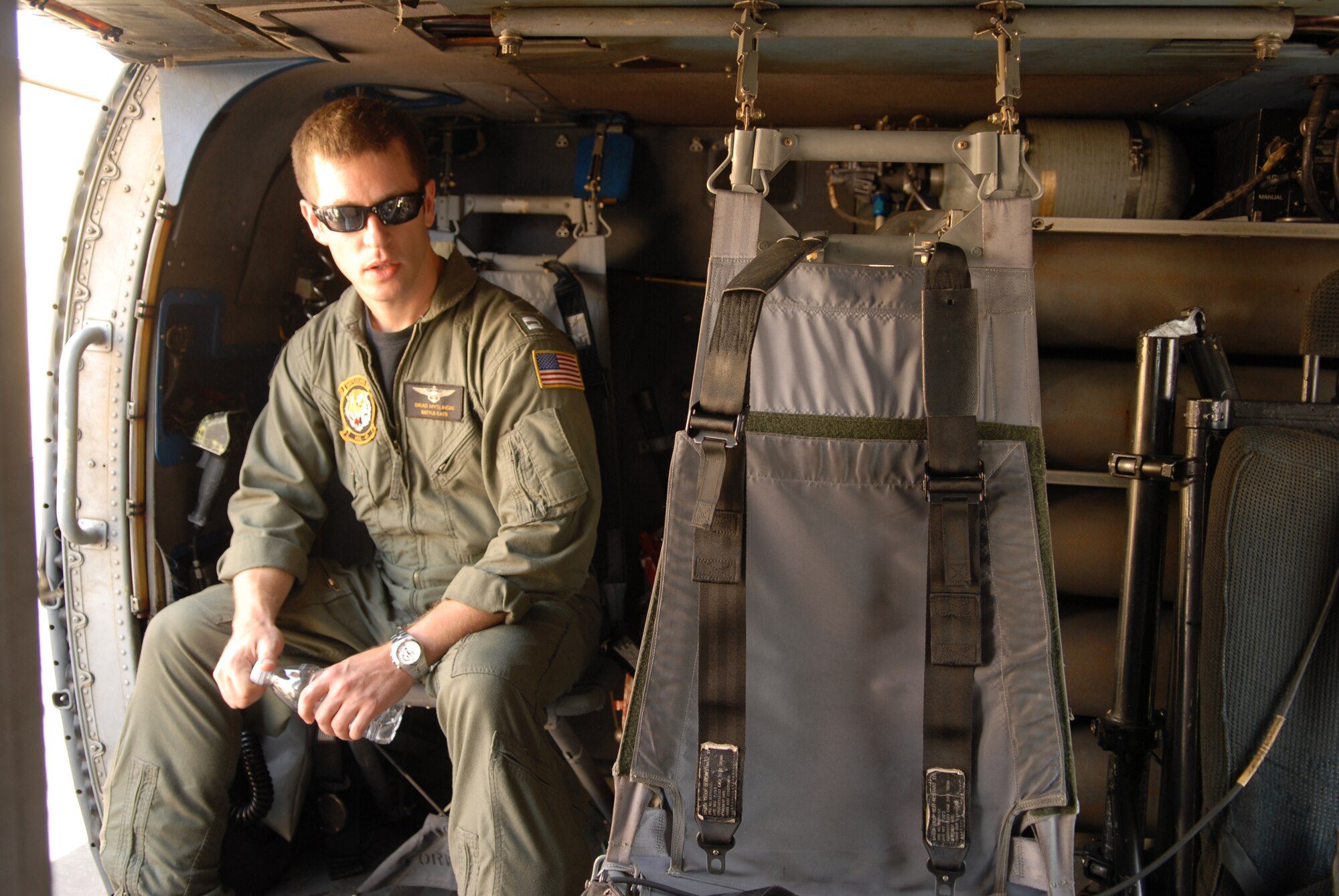 SANTA MARIA, Calif. - Sitting in a SH60-Bravo helicopter, Navy Lt. Brad Mylinski explains the primary mission of the Helicopter Anti Submarine Squadron Light-43 pilots during the Thunder Over the Valley Fly-In Aug. 29 here. The SH60-Bravo helicopter the Battle Cats fly are weapons-system capable and utilize the M-60, M-240 and GAU-16. (U.S. Air Force photo by/Airman 1st Class Angelina DellaRocco-Rukavina)

