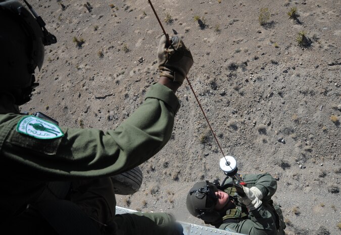 (left) Tech. Sgt. Mark Moore operates a breeze eastern hoist while lifting Staff Sgt. Lane Miller into an HH-60 Pave Hawk during a rescue operation training scenario in the Nevada desert Aug. 24, 2009. Both are aerial gunners assigned to the 66th Rescue Squadron, Nellis Air Force Base, Nev. 
(U.S. Air Force photo/ Master Sgt. Kevin J. Gruenwald) 



















  












 











































  












 

























