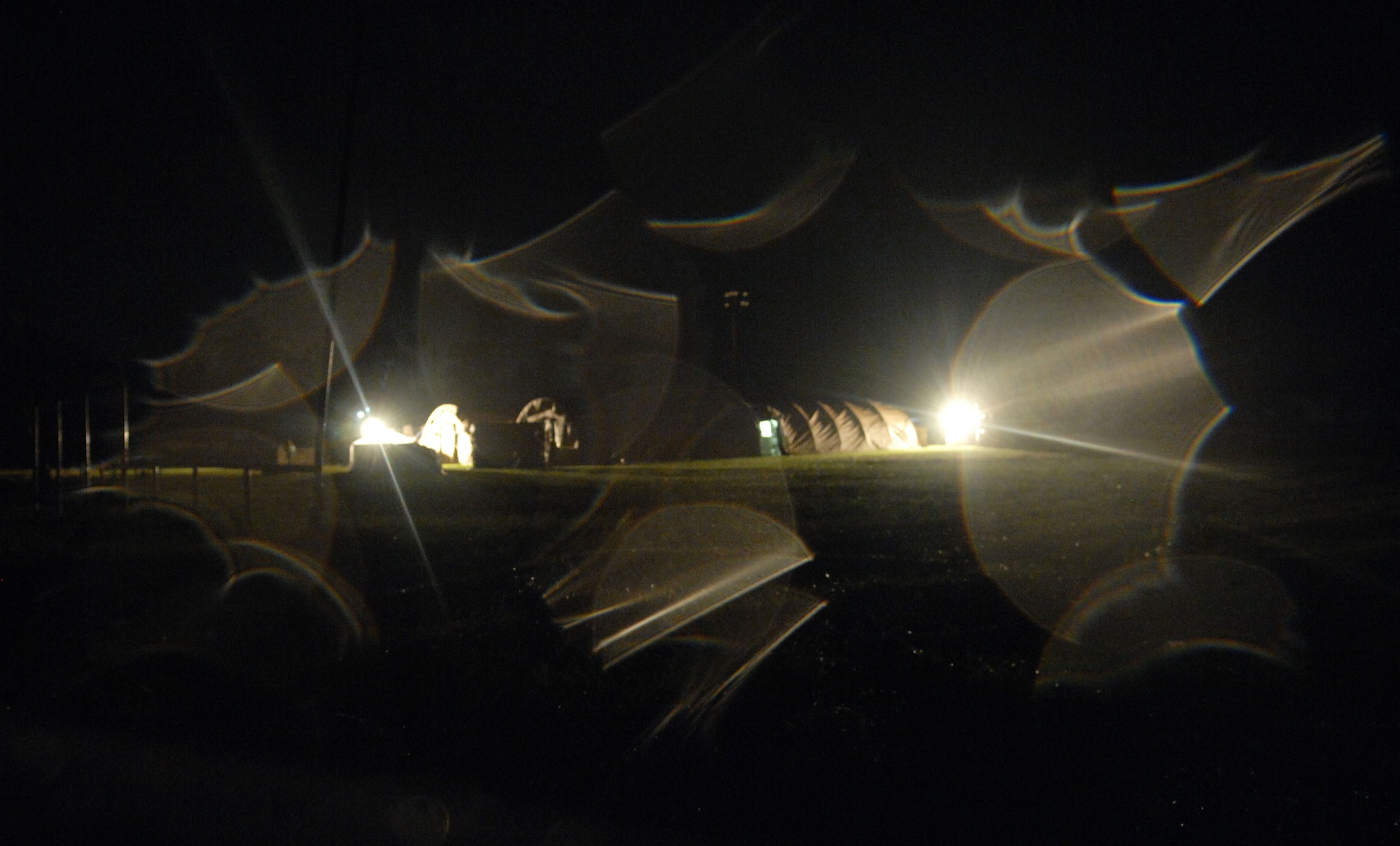 Humanitarian Assistance Rapid Response Team members work into the rainy night to construct medical tents during a validation exercise Sept. 2 on Chuuk in the Federated States of Micronesia.  The HARRT is the Air Force?s new expeditionary medical capability designed to deploy within 24 hours of notice during disaster relief operations.  During the deployment, the team will treat 350 to 500 Chuukese patients per day.  (U.S. Air Force photo/Capt. Andrew Hoskinson)