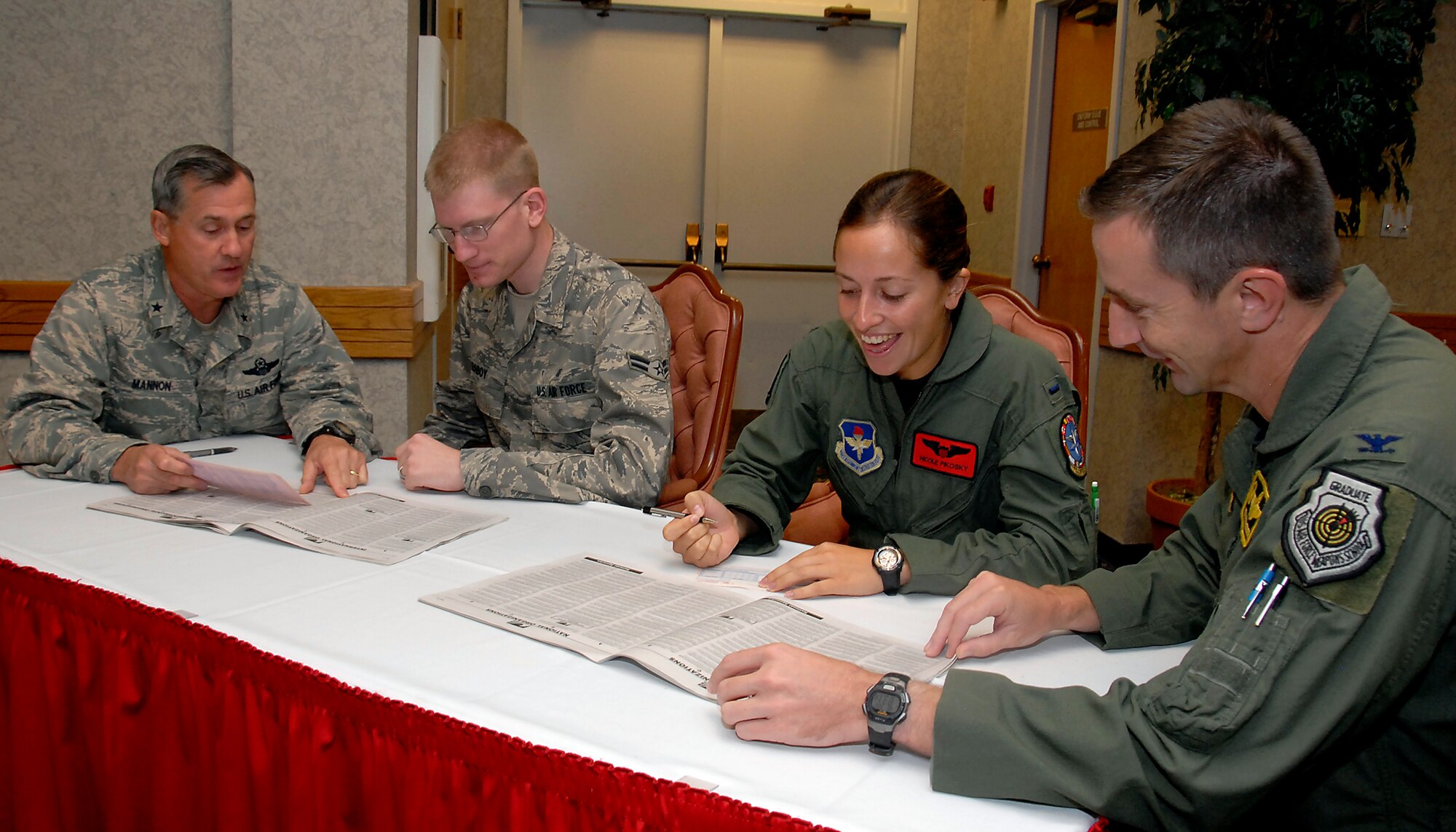 Brig. Gen. O.G. Mannon, 82nd Training Wing commander left, and Col. Kevin Schneider 80th Flying Training Wing commander, right, fill out Combined Federal Campaign fund forms Sept. 2 with 1st Lt. Nicole Pikosky, an 89th Flying Training Squadron, T-6 instructor pilot, middle right, and Airman 1st Class Drew Raboy, middle left, a mental health technician with 82nd Medical Operations Squadron, Alcohol and Drug Abuse Prevention and Treatment. Sheppard’s fund-raising cycle began Sept. 2 and will continue through Oct. 17. (U.S. Air Force photo/Mike Litteken)