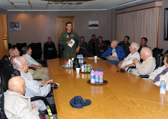 MINOT AIR FORCE BASE, N.D. -- Col. Julian Tolbert (pictured standing), 23rd Bomb Squadron vice commander, discusses the current operational Air Force with members of the 23rd Bomb Squadron reunion tour here, Aug. 28. The members of the 23rd Bomb Squadron reunion tour served during World War II in the South Pacific as pilots, co-pilots and aerial gunners aboard the B-24 Liberator. (U.S. Air Force photo by Staff Sgt. Keith Ballard)