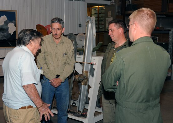 MINOT AIR FORCE BASE, N.D. -- Mr. Joe Shields (pictured far left), 23rd Bomb Squadron reunion tour member, discusses what it was like for an Air Force member in World War II with Mr. Glenn Blackaby (pictured tan shirt), Minot Air Museum curator, Mr. Robert Michel (pictured green jacket), 5th Bomb Wing historian, and Capt. Travis Carter (pictured flight suit), 23rd Bomb Squadron electronics warfare officer, at the Minot Air Museum, Aug. 28. The members of the 23rd Bomb Squadron reunion tour served during World War II in the South Pacific as pilots, co-pilots and aerial gunners aboard the B-24 Liberator. (U.S. Air Force photo by Staff Sgt. Keith Ballard)