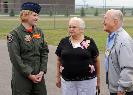 MINOT AIR FORCE BASE, N.D. -- 1st Lt. Corrine Hester, 23rd Bomb Squadron navigator, greets Mr. and Mrs. George Crippen, 23rd Bomb Squadron reunion tour members, as they arrive at the Minot Air Museum, Aug. 28. The members of the 23rd Bomb Squadron reunion tour served during World War II in the South Pacific as pilots, co-pilots and aerial gunners aboard the B-24 Liberator. (U.S. Air Force photo by Staff Sgt. Keith Ballard)