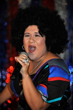 Sabrina Begay won first place in the Charleston Air Mobility Command Icon talent contest by singing "I Will Survive" Aug. 28. The AMC Icon competition is based loosely on the "American Idol" television show, and each act was reviewed by a team of judges on several categories, including technical excellence and showmanship. Sabrina Begay is the wife of Staff Sgt. Marc Begay who is with the 437th Aircraft Maintenance Squadron. (U.S. Air Force photo/James M. Bowman)