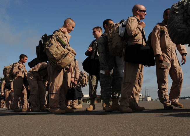 Airmen prepare to board a Boeing 757 aircraft on the flightline here for a deployment Aug. 29, including members of the 17th Airlift Squadron supporting Operation Enduring Freedom. The 17 AS will perform airland and airdrop missions while deployed, providing a bridge for the movement of supplies to ground forces. (U.S. Air Force photo/Senior Airman Gieratz)