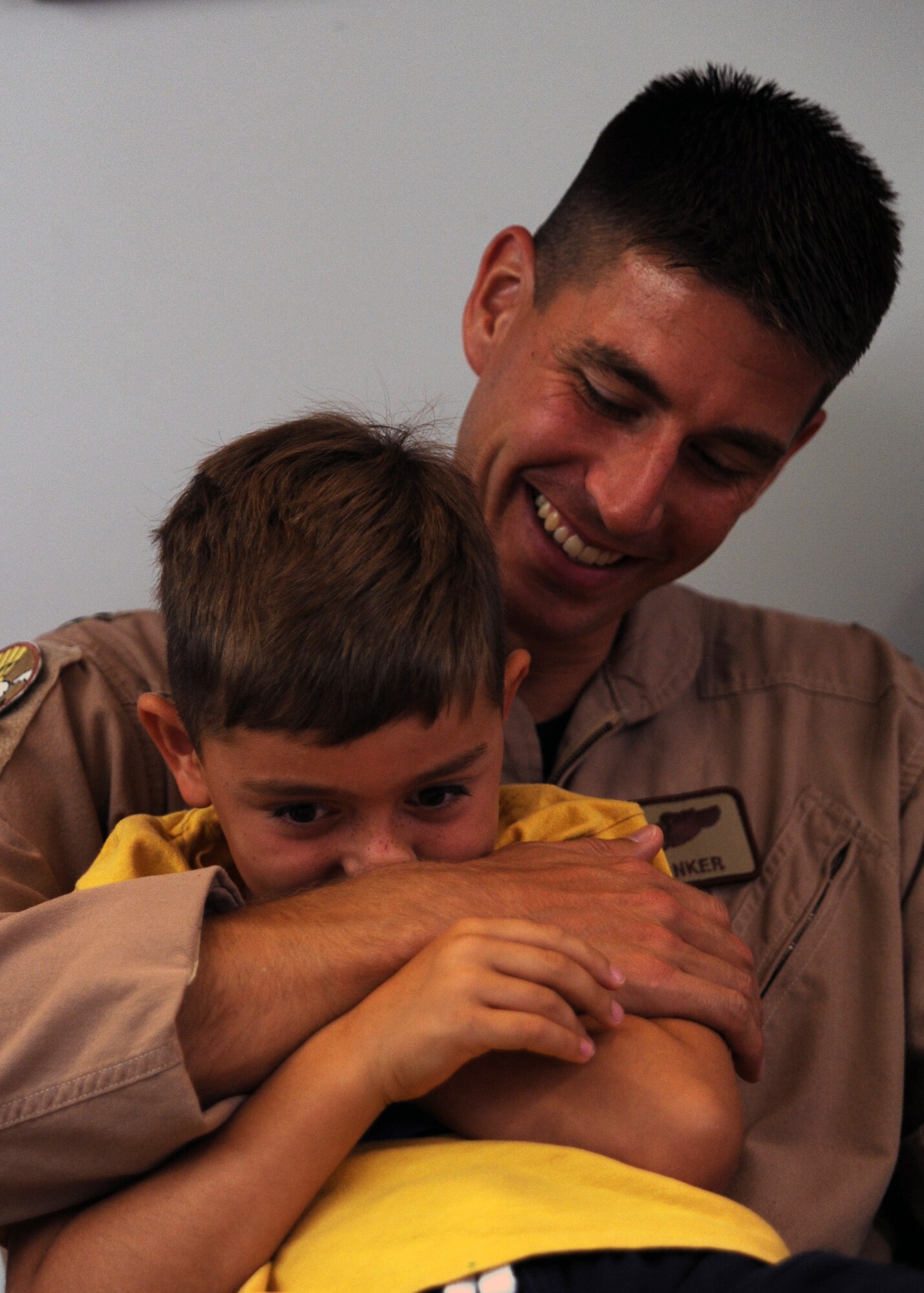 Capt. Matthew Tinker plays with his son Noah at the passenger terminal here a few hours before deploying Aug. 29. Captain Tinker, along with approximately 110 members of the 17th Airlift Squadron, deployed from Charleston as part of the two Expeditionary Airlift concept and will be assigned to the 816th Expeditionary Airlift Squadron. Captain Tinker is a pilot with the 17 AS. (U.S. Air Force photo/Senior Airman Gieratz)