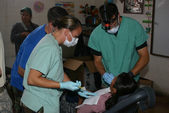 Senior Airman Ashley Guilbeault (left), 189th Medical Group dental technician, and Maj. (Dr.) Tom Phelan, U.S. Air Force Academy assistant professor, treat a patient Aug. 3 at Baja Vera Pez, Guatemala. Medical groups from the Arkansas Air National Guard's 189th Airlift Wing and the 188th Fighter Wing completed a Joint Forces Medical Readiness Exercise deployment Aug. 15. (U.S. Air Force photo by Master Sgt. Eric Pipkin)