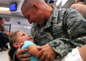 Senior Airman Shawn Patterson plays with his daughter Alanna at the passenger terminal here while waiting for his flight to the Middlge East Aug. 29. Airman Patterson, along with approximately 110 members of the 17th Airlift Squadron, deployed from Charleston in support of Operation Enduring Freedom. Airman Patterson is a firefighter and deployed from Shaw AFB, S.C. (U.S. Air Force photo/Senior Airman Gieratz)