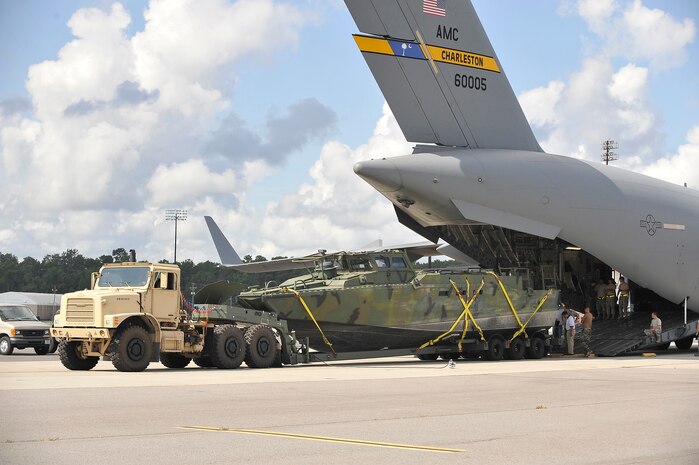 A Navy Riverine Command Boat and trailer onto a C-17 at Charleston AFB Aug. 26. The U.S. Navy's Riverine Group 1 is testing the RCB, which gives riverine squadron's a primary boat in combat missions, patrolling missions, as a combat information center which can be configured as an ambulance boat. (U.S. Air Force photo/James M. Bowman(