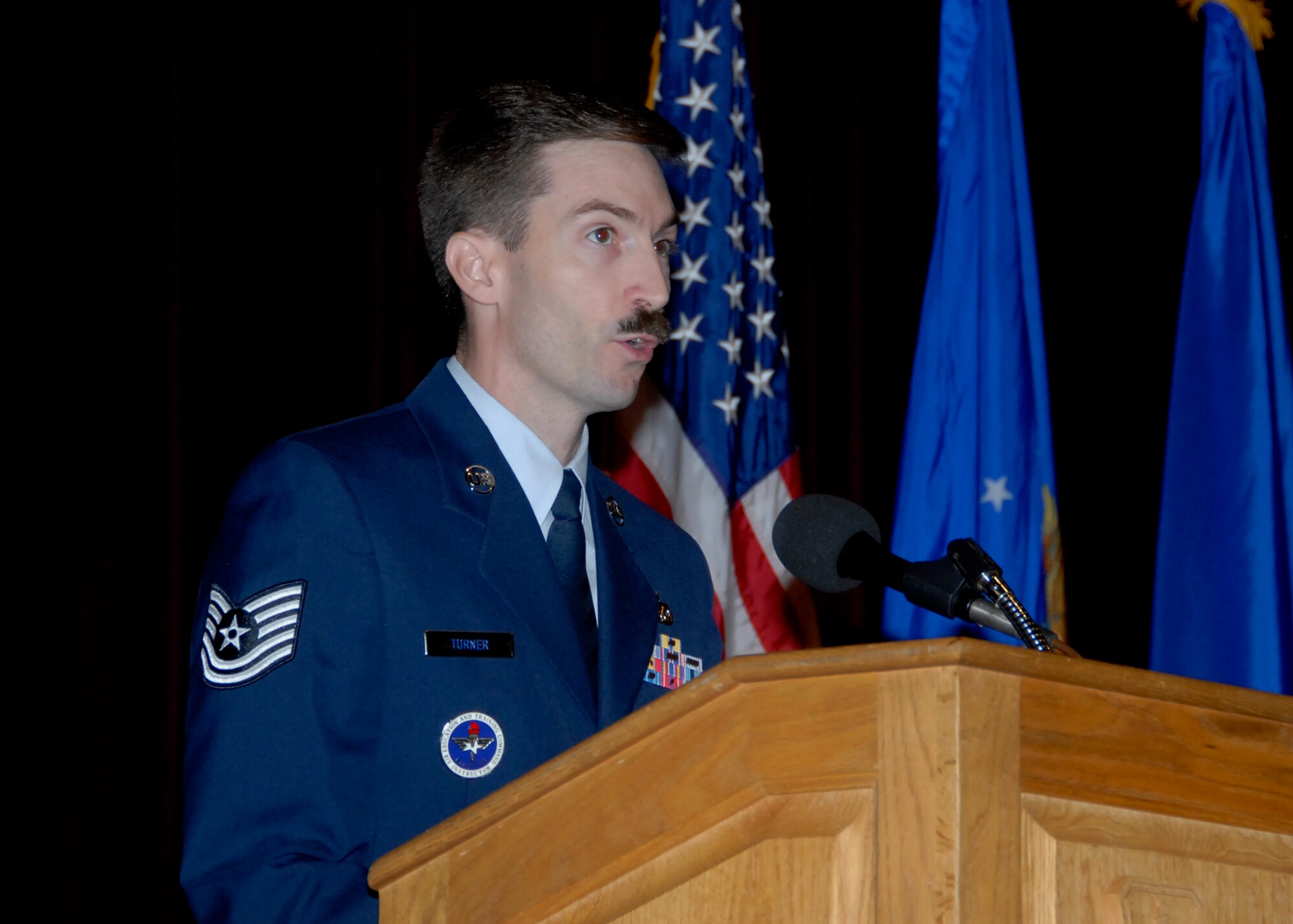 Tech. Sgt. Scott Turner speaks to the newly- promoted senior airman at the NCO induction ceremony Aug. 28 at the base theater. Fifty-five senior airmen were selected for staff sergeant. (U.S. Air Force photo/ Mike Litteken)