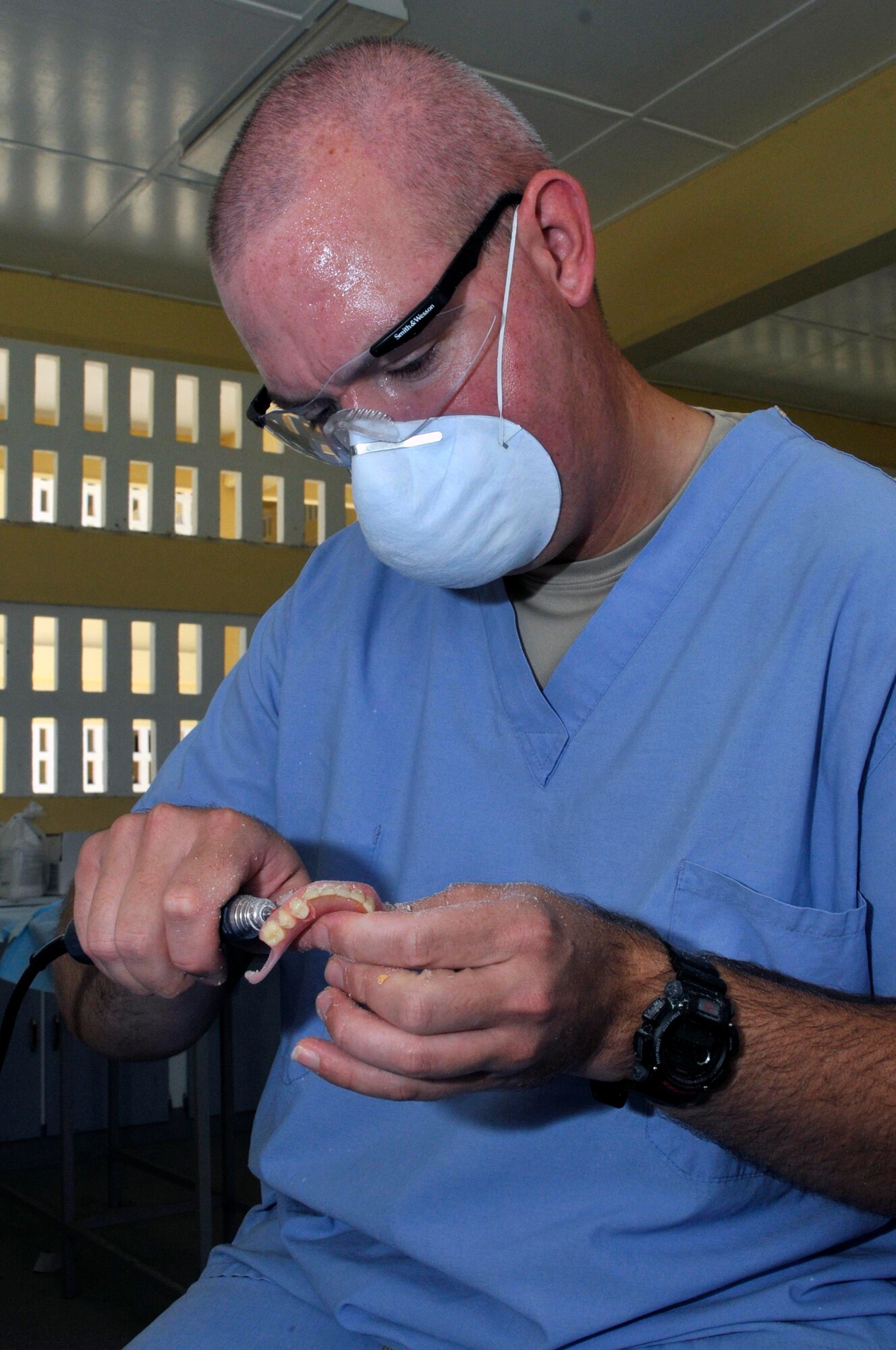 Tech Sgt. Brian Arendes, dental laboratory technician, 75th Dental Squadron, Hill AFB, Utah, rounds of the edges of a new denture with a dremel sander Aug. 25, 2009, at Diamond Secondary School in Georgetown, Guyana. Airmen from Hill AFB are participating in the third and final dental rotation for New Horizons Guyana 2009. (U.S. Air Force photo by Airman 1st Class Perry Aston) (Released)