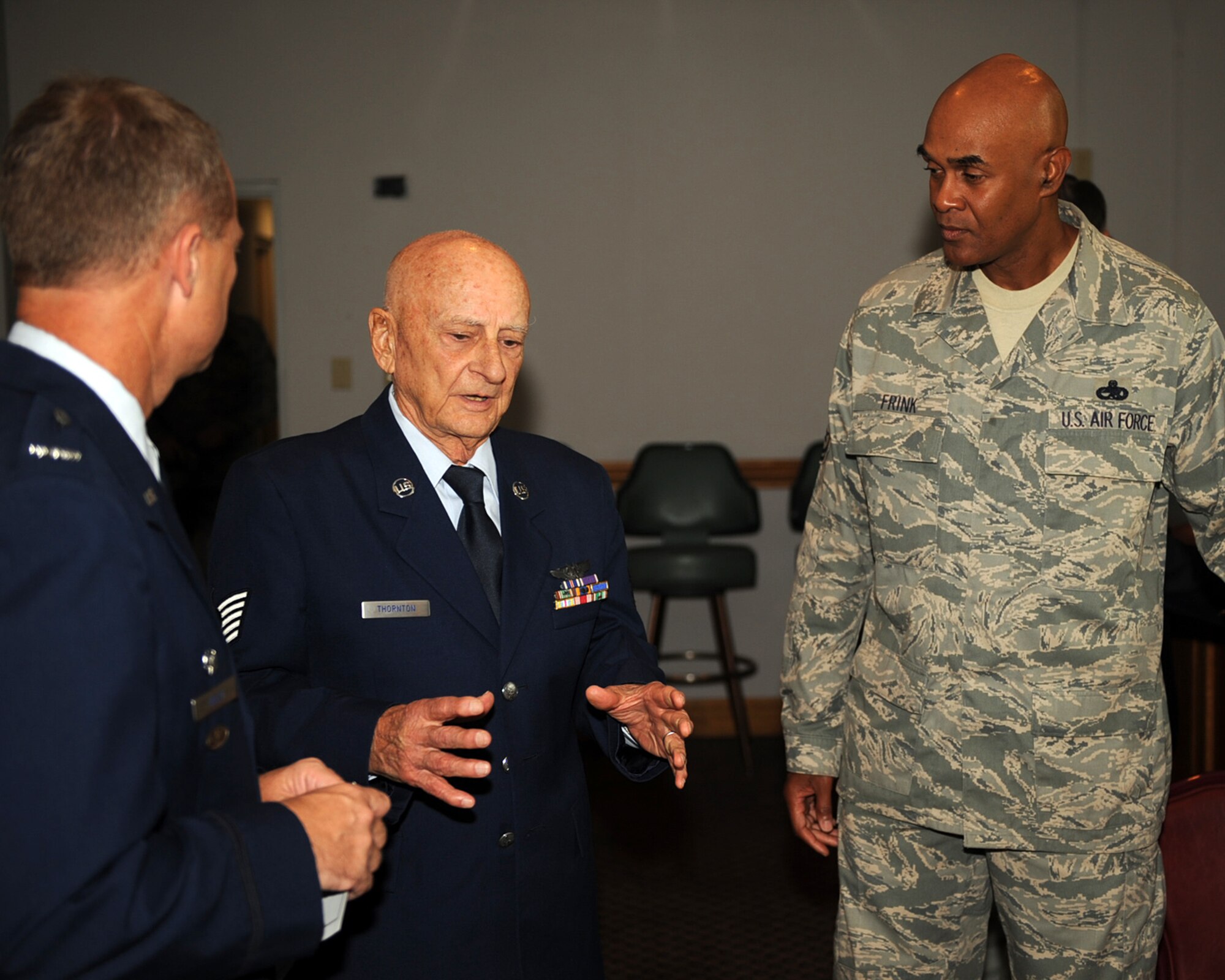 World War II veteran Tech Sgt. Holt Thornton speaks with Col. Mark Kelly, 4th Fighter Wing commander and Command Chief Master Sgt. Leroy Frink, after a medal presentation ceremony on Seymour Johnson Air Force Base, N.C., Aug. 29, 2009. Colonel Kelly presented Mr. Thornton with five medals for his service during WWII, including The Purple Heart and Air Medal. Mr. Thornton was a B-24 aerial gunner while part of the Army Air Corp, and spent his last three months in the service here. (U.S. Air Force photo by Senior Airman Ciara Wymbs)