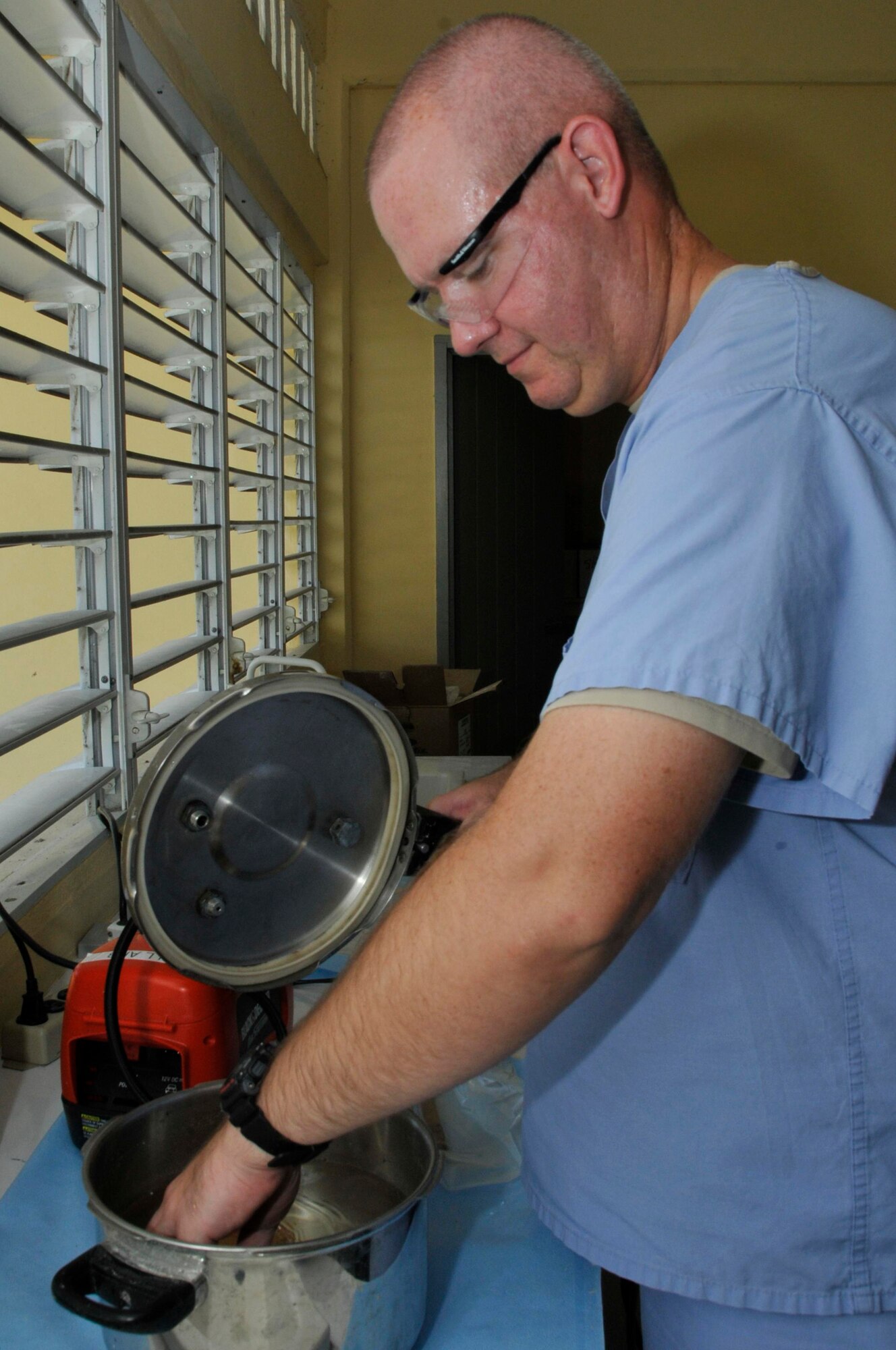 Tech Sgt. Brian Arendes, dental laboratory technician, 75th Dental Squadron, Hill AFB, Utah, sets dentures into pressure cooker filled with water, to harden Aug. 25, 2009, at Diamond Secondary School in Georgetown, Guyana. Airmen from Hill AFB are participating in the third and final dental rotation for New Horizons Guyana 2009. (U.S. Air Force photo by Airman 1st Class Perry Aston) (Released)
