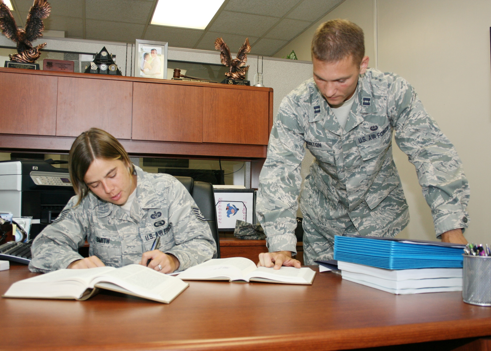 Capt. Andrew Norton and Tech. Sgt. Crystal Smith review documents at the Area Defense Council building at Eglin Air Force Base. The ADC represents members who may receive adverse career actions against them. The ADC handles actions such as Articles 15, referral enlisted performance reports, letters of reprimand, and unfavorable discharges. (Air Force photo/ 2nd Lt. Andrew Caulk.)