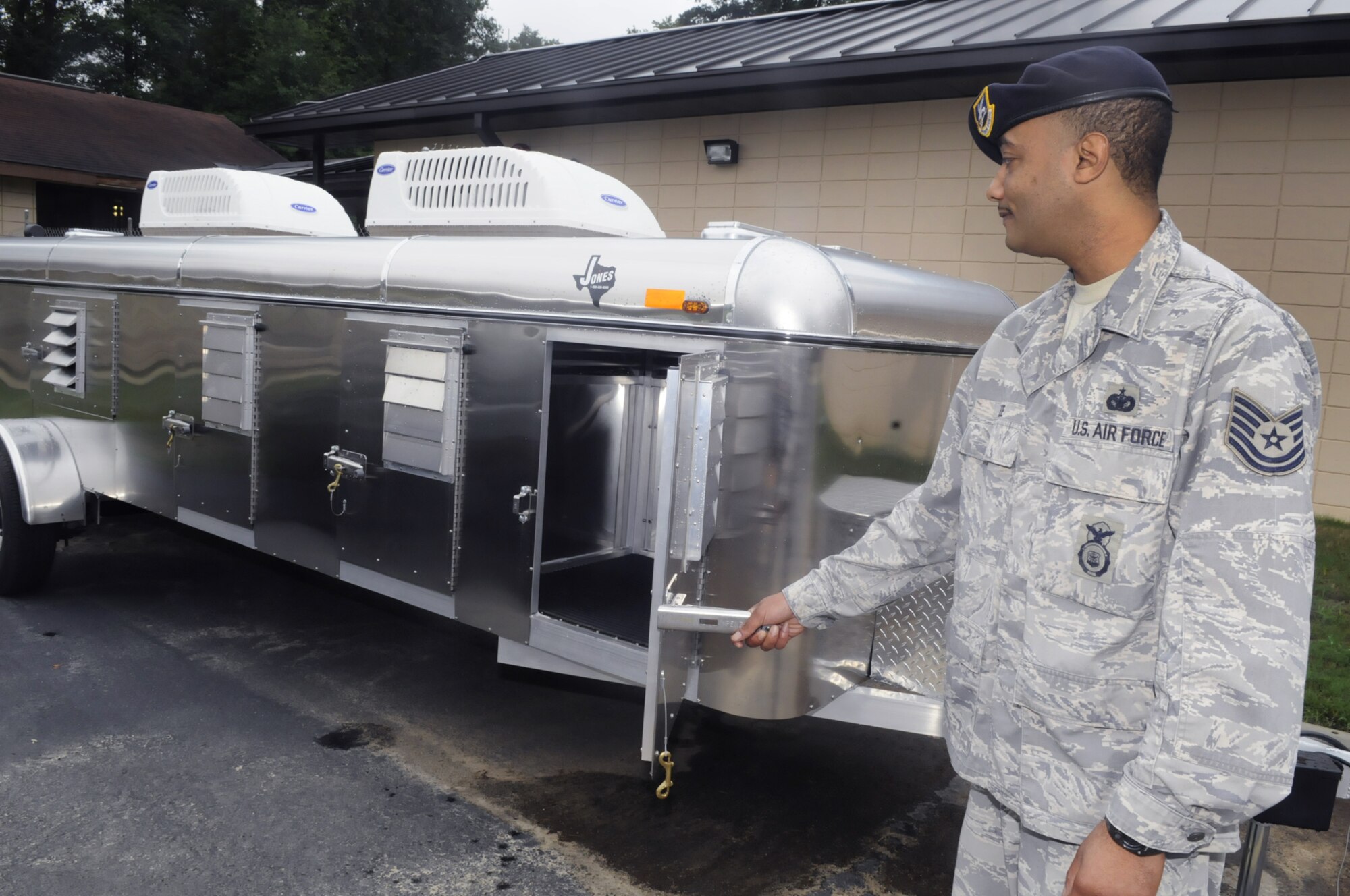 TSgt. Derrick Lee, kennel master for the 78th SFS, shows the trailer that can house the dogs if needed. U. S. Air Force photo by Sue Sapp