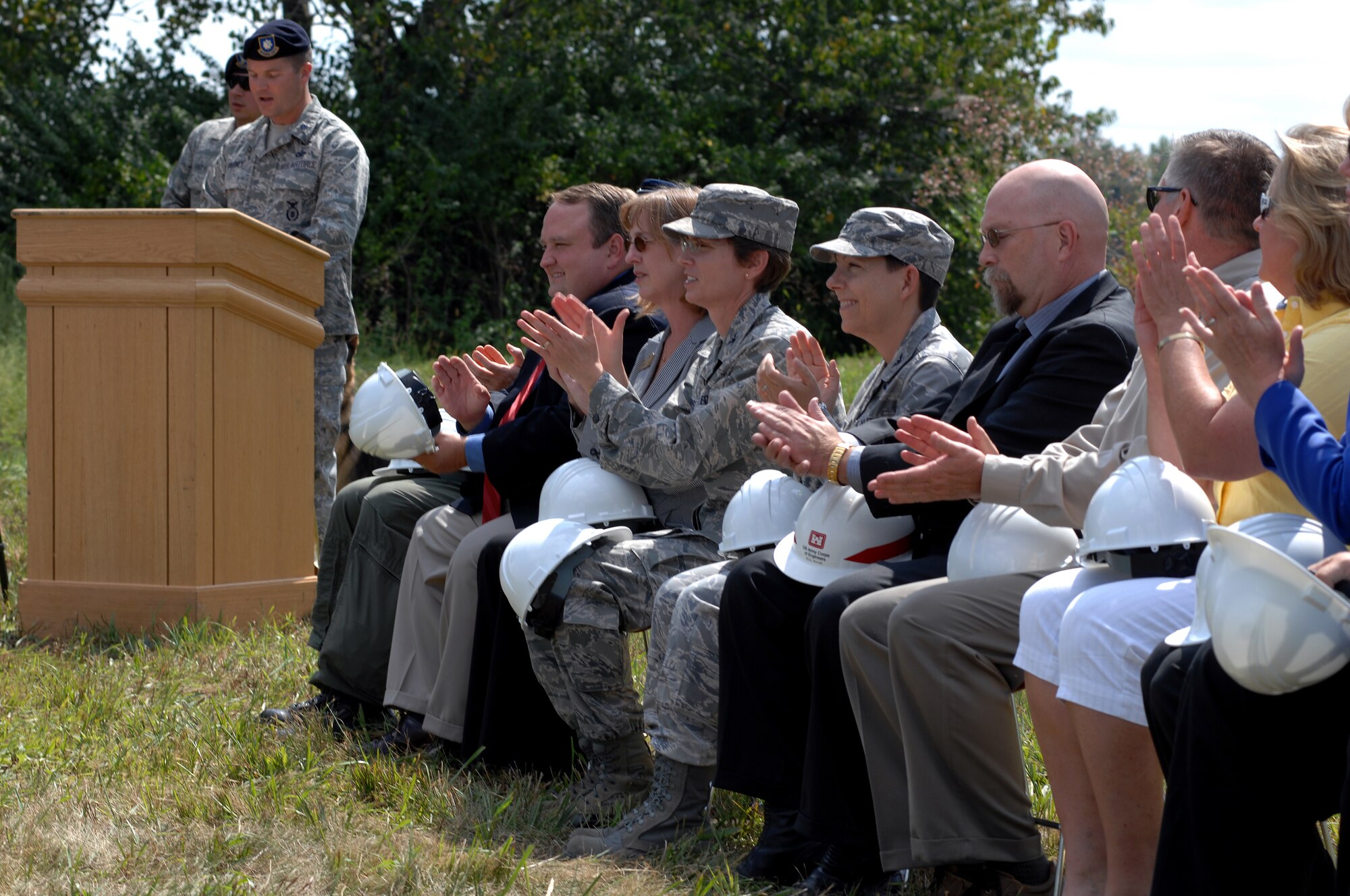 WHITEMAN AIR FORCE BASE, Mo. - Distinguished visitors in attendance during a ground breaking ceremony applaud for the accomplishments of the plans for a new military working dog facility, Sept. 1. (U.S. Air Force photo/Senior Airman Kenny Holston)  