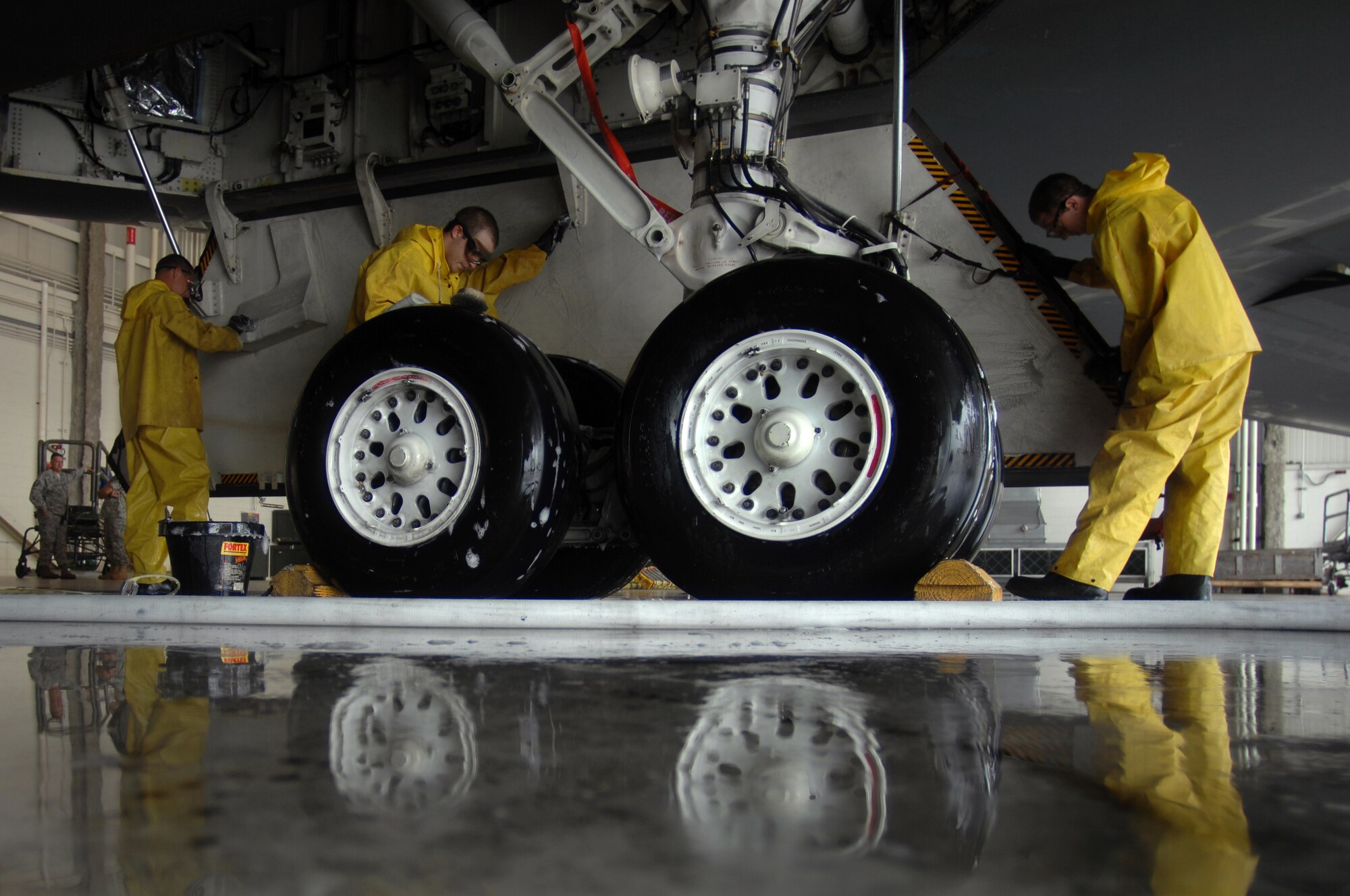 WHITEMAN AIR FORCE BASE, Mo. - Crew chiefs assigned to the 509th Aircraft Maintenance Squadron scrub down a B-2 Spirit during a full wash, Aug. 27. A full wash is conducted on a B-2 Spirit every 180 days and consists of three, six- to ten-men crews whowork around the clock to get the job done within one to two days. (U.S. Air Force photo/Senior Airman Kenny Holston)