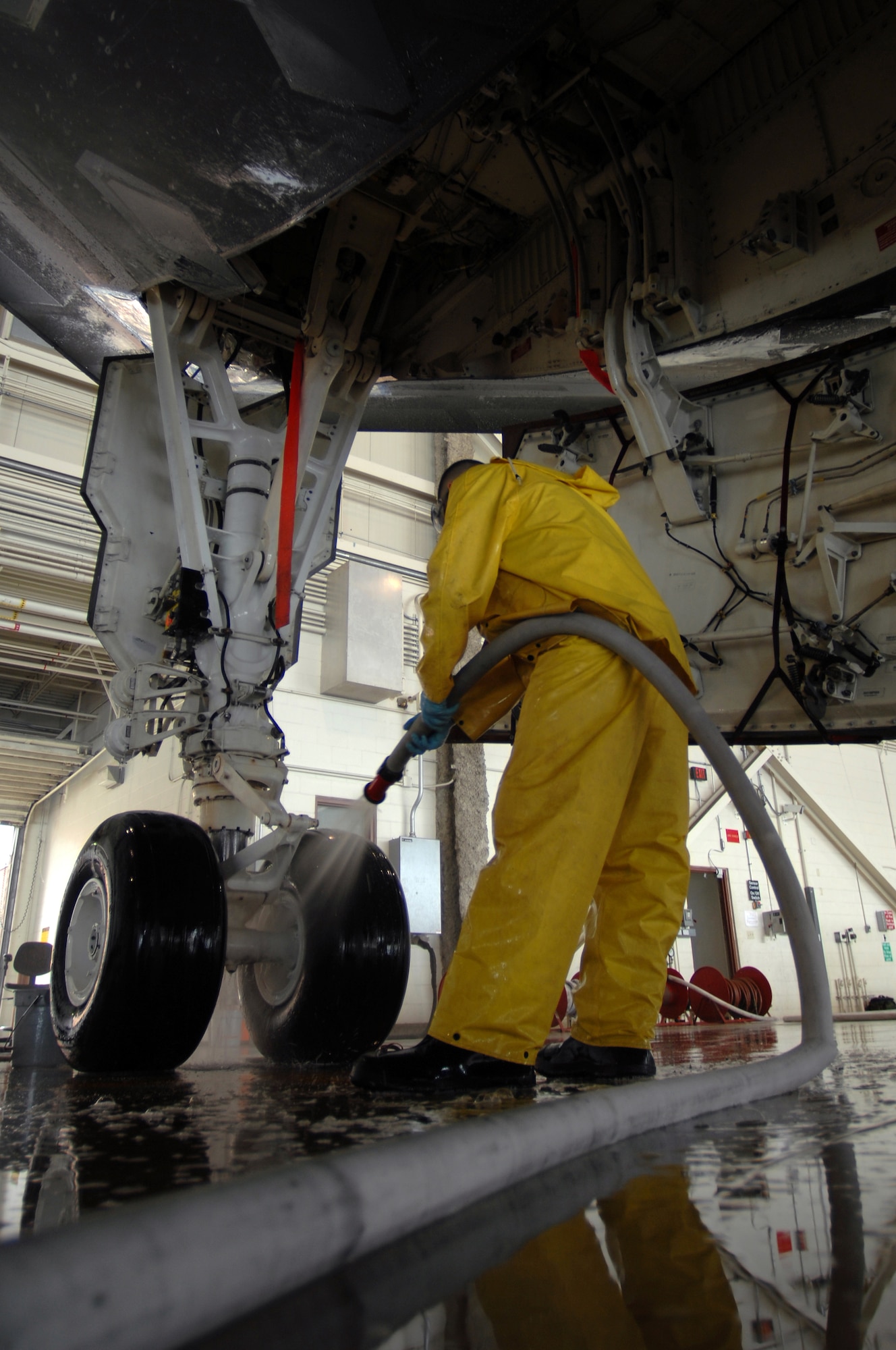 WHITEMAN AIR FORCE BASE, Mo. - Airman 1st Class Patrick Holter, a crew chief assigned to the 509th Aircraft Maintenance Squadron sprays down a B-2 Spirit during a full wash Aug. 27. A full wash is conducted on a B-2 Spirit every 180 days and consists of three, six- to ten-men crews that work around the clock to get the job done within one to two days. (U.S. Air Force photo/Senior Airman Kenny Holston)