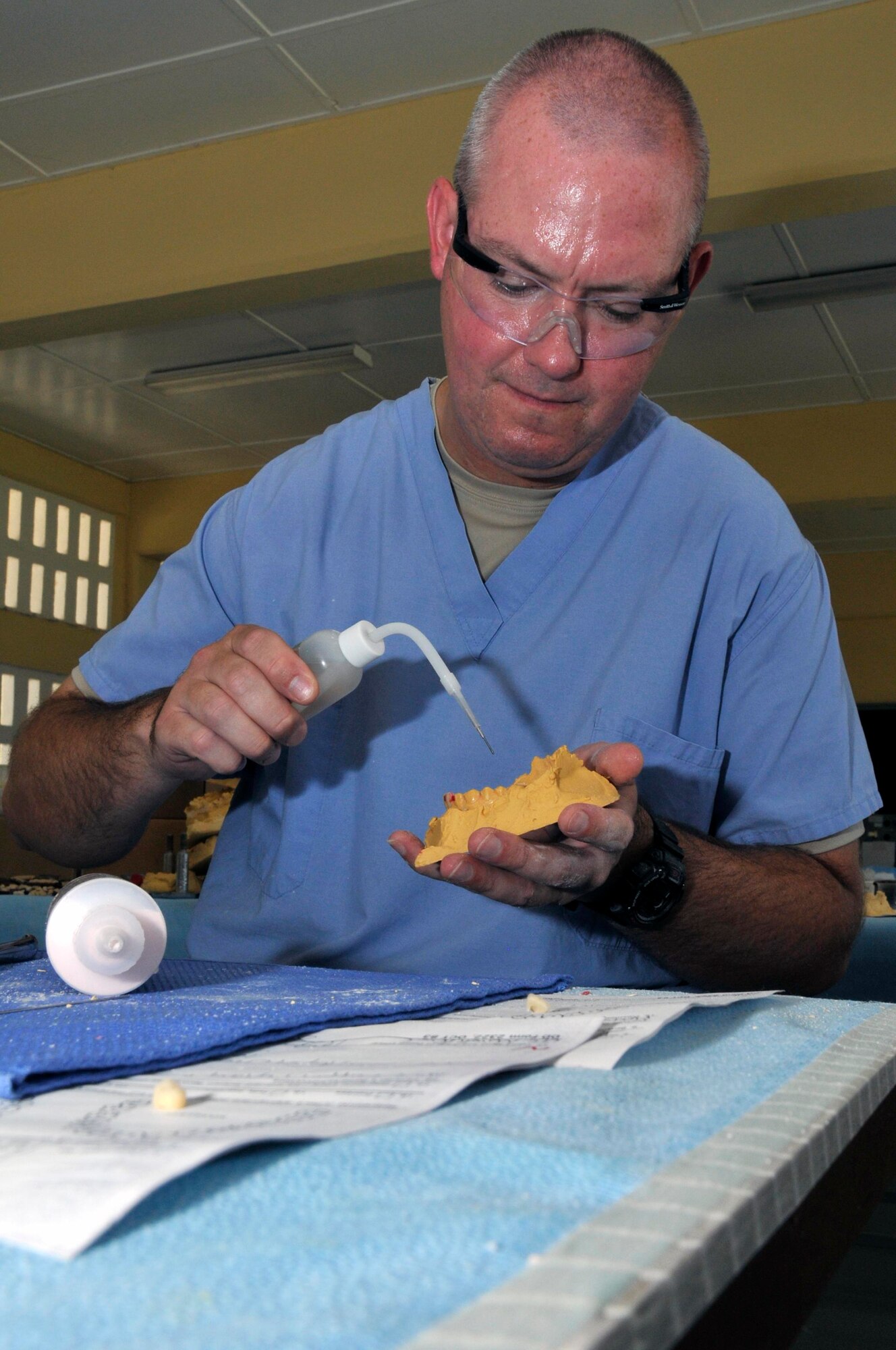 Tech Sgt. Brian Arendes, dental laboratory technician, 75th Dental Squadron, Hill AFB, Utah, pours liquid acrylic into a mold Aug 25, 2009, at Diamond Secondary School in Georgetown, Guyana. Airmen from Hill AFB are participating in the third and final dental rotation for New Horizons Guyana 2009. (U.S. Air Force photo by Airman 1st Class Perry Aston) (Released)