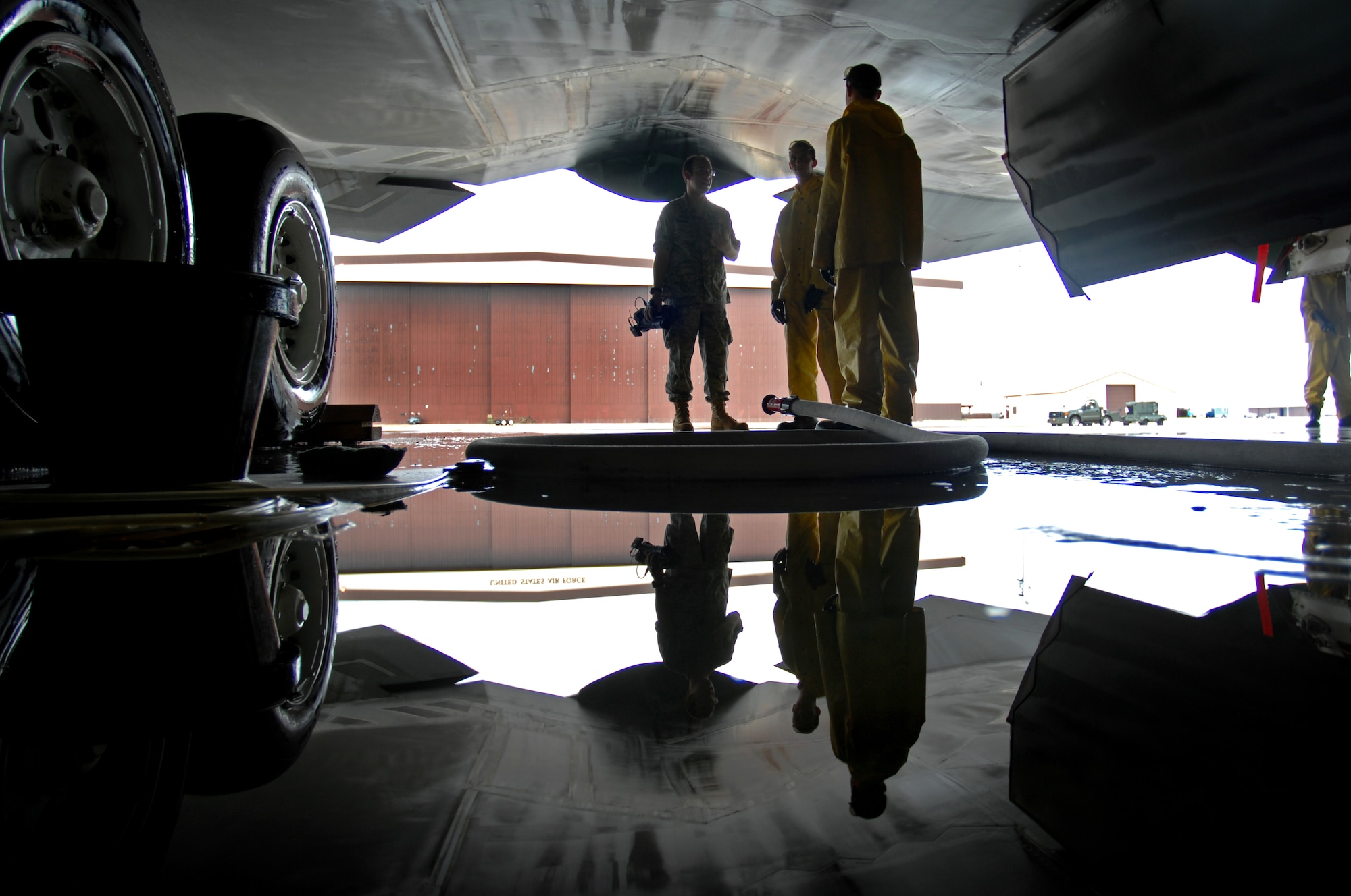 WHITEMAN AIR FORCE BASE, Mo. - Crew chiefs assigned to the 509th Aircraft Maintenance Squadron scrub down a B-2 Spirit during a full wash, Aug. 27. A full wash is conducted on a B-2 Spirit every 180 days and consists of three, six- to ten-men crews whowork around the clock to get the job done within one to two days. (U.S. Air Force photo/Senior Airman Kenny Holston)