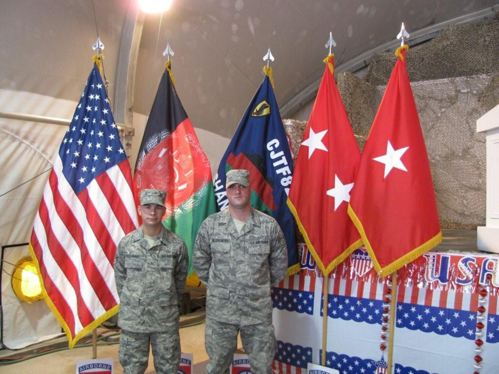 Two Westover Airmen took part in a Fourth of July joint re-enlistment ceremony held at Bagram Air Force Base.  Staff Sgt. Gregory Paczkowski and Senior Airman Anthony Tassinari both re-enlisted as part of the ceremony that was officiated by Major General Curtis M. Scaparrotti, United States Army, Commander of the 82nd Airborne. The ceremony took place in the Clamshell at Bagram AFB. The Combined Joint Task Force-82 Band performed the Army, Marine, Navy and Air Force songs in recognition of each branch.  Each re-enlistee was presented the Major General?s coin.