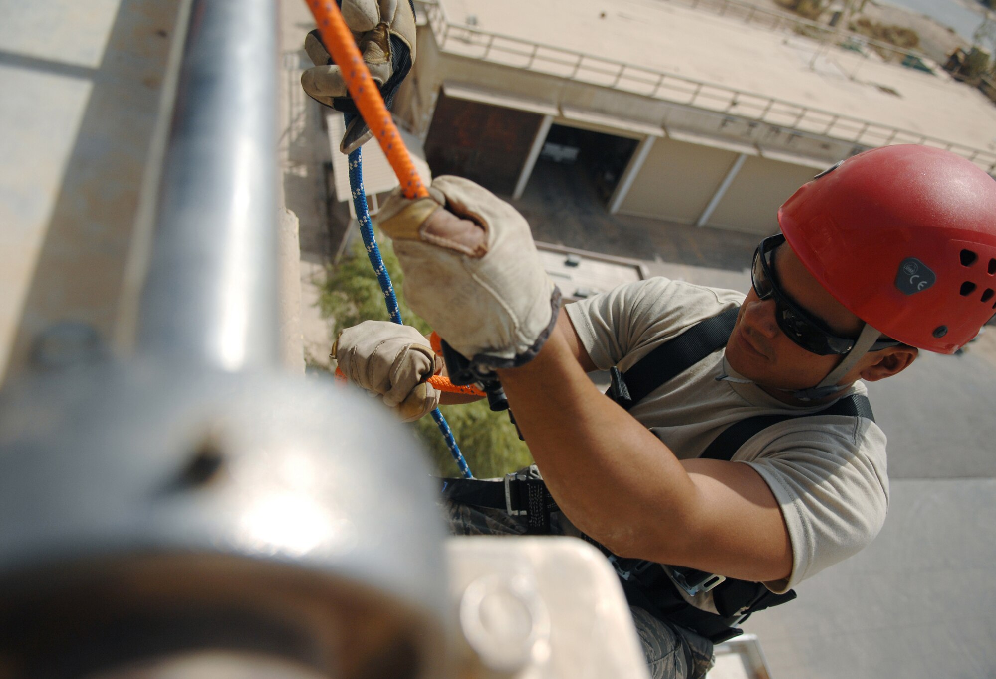 Airman 1st Class Hector Garcia, a firefighter with the 332nd Expeditionary Civil Engineer Squadron, prepares to rappel down the side of the control tower during a training exercise Aug. 20, 2009, at Joint Base Balad, Iraq. (U.S. Air Force photo/Senior Airman Christopher Hubenthal)