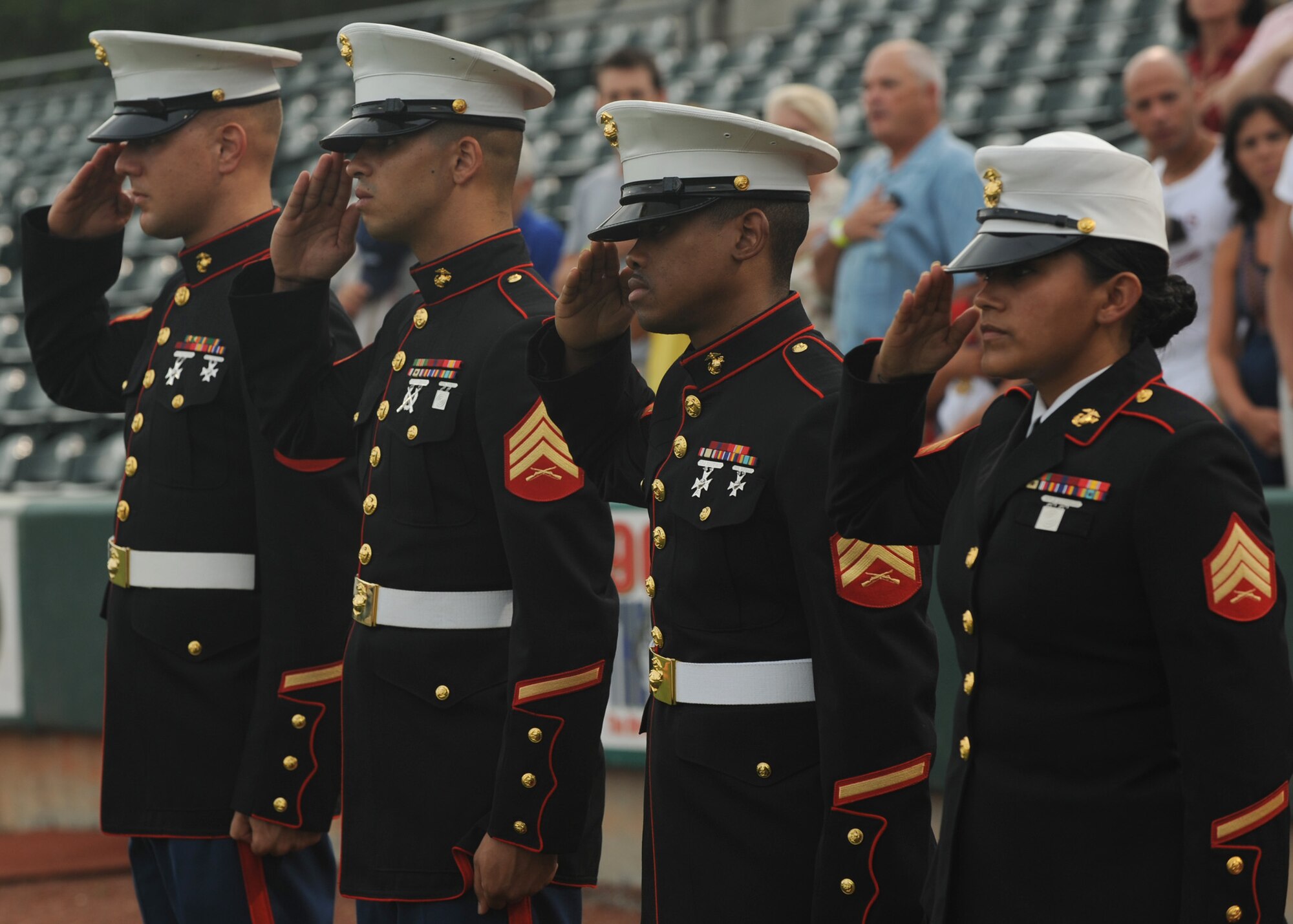 A team of Marines render salutes during the singing of the national anthem at a Charleston RiverDogs baseball at Joseph P. Riley Jr. Park during the military appreciation night Aug. 26. The military appreciation night was free for all military and Department of Defense identification card holders and their families. (U.S. Air Force photo/Senior Airman Katie Gieratz)