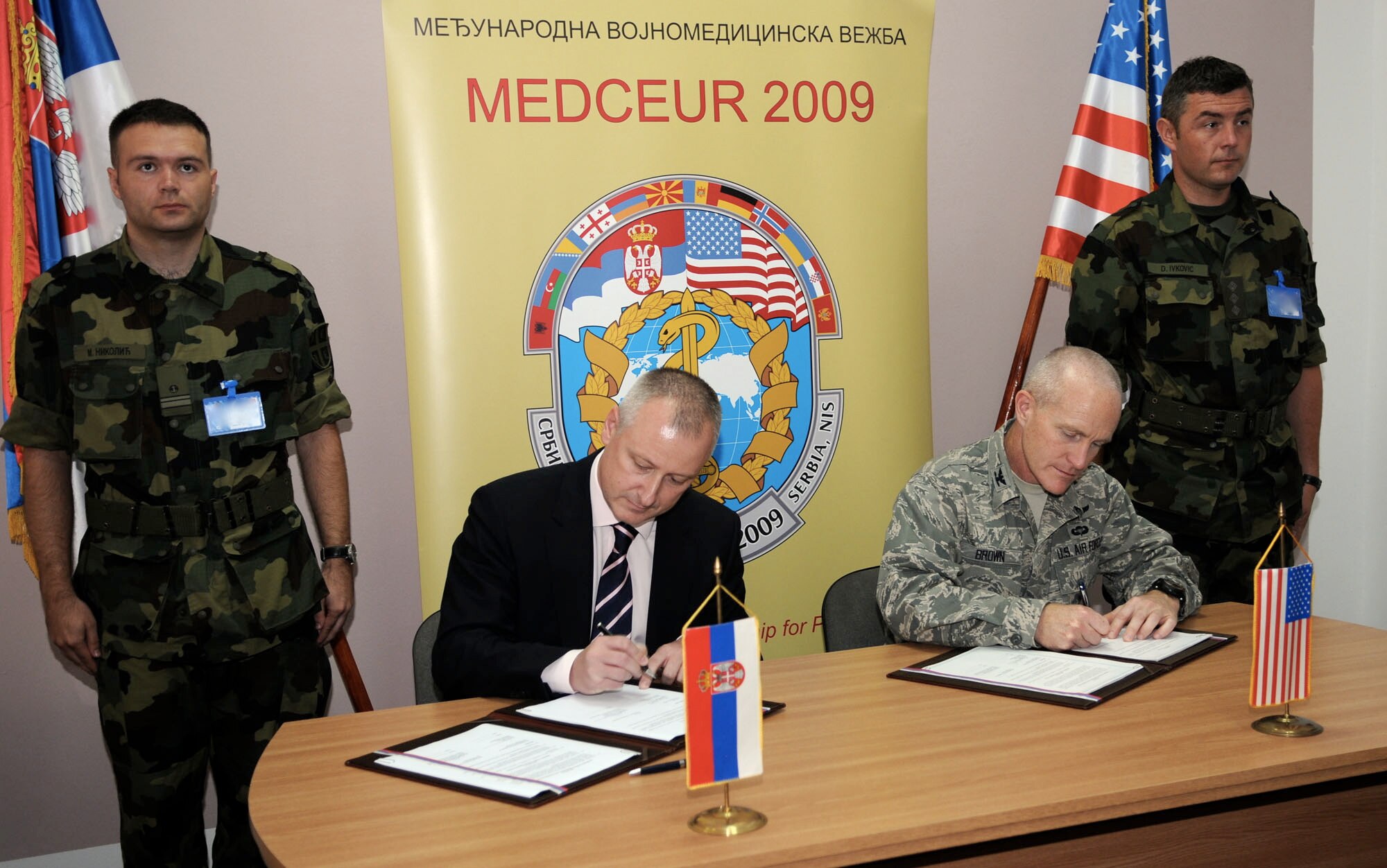 NIS, Serbia – Col. Tim Brown, 435th Expeditionary Contingency Response Group commander and MEDCEUR 2009 co-director, and Dr. Zoran Vesic, a Serbian state secretary, officially signs the event memorandum and technical agreement before the opening ceremony of the 2009 military medical training exercise in Central and Eastern Europe Wednesday, Sept. 2, 2009 at Knjaz Mihailo Barracks here. More than 600 participants, including hundreds of Unites States Air Forces in Europe Airmen, descended upon Nis to participate in the Sept. 2 - 13 exercise. The exercise focuses on providing joint medical training and assisting host nation civilian and military services; international, private and volunteer organizations; and other participating nations in enhancing disaster response actions.