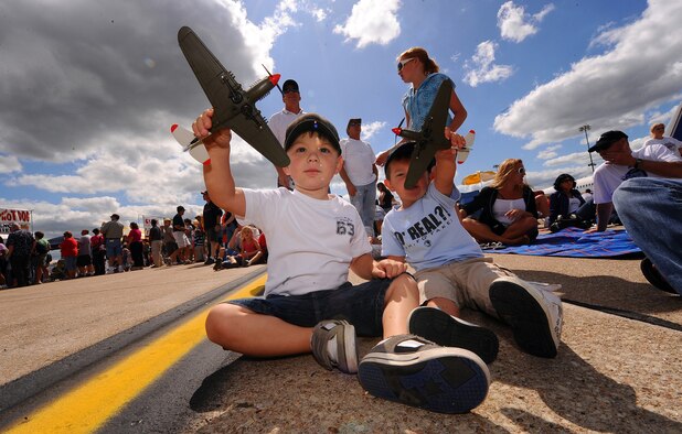 OFFUTT AIR FORCE BASE Neb. -- Three-year-old Brandon Kiger (left) and Two-year-old Jack Real (right), play with toy airplanes prior to the U.S. Navy's Blue Angels performance at the 2009 Defenders of Freedom Open House and Air Show Aug. 29. U.S. Air Force Photo by Josh Plueger