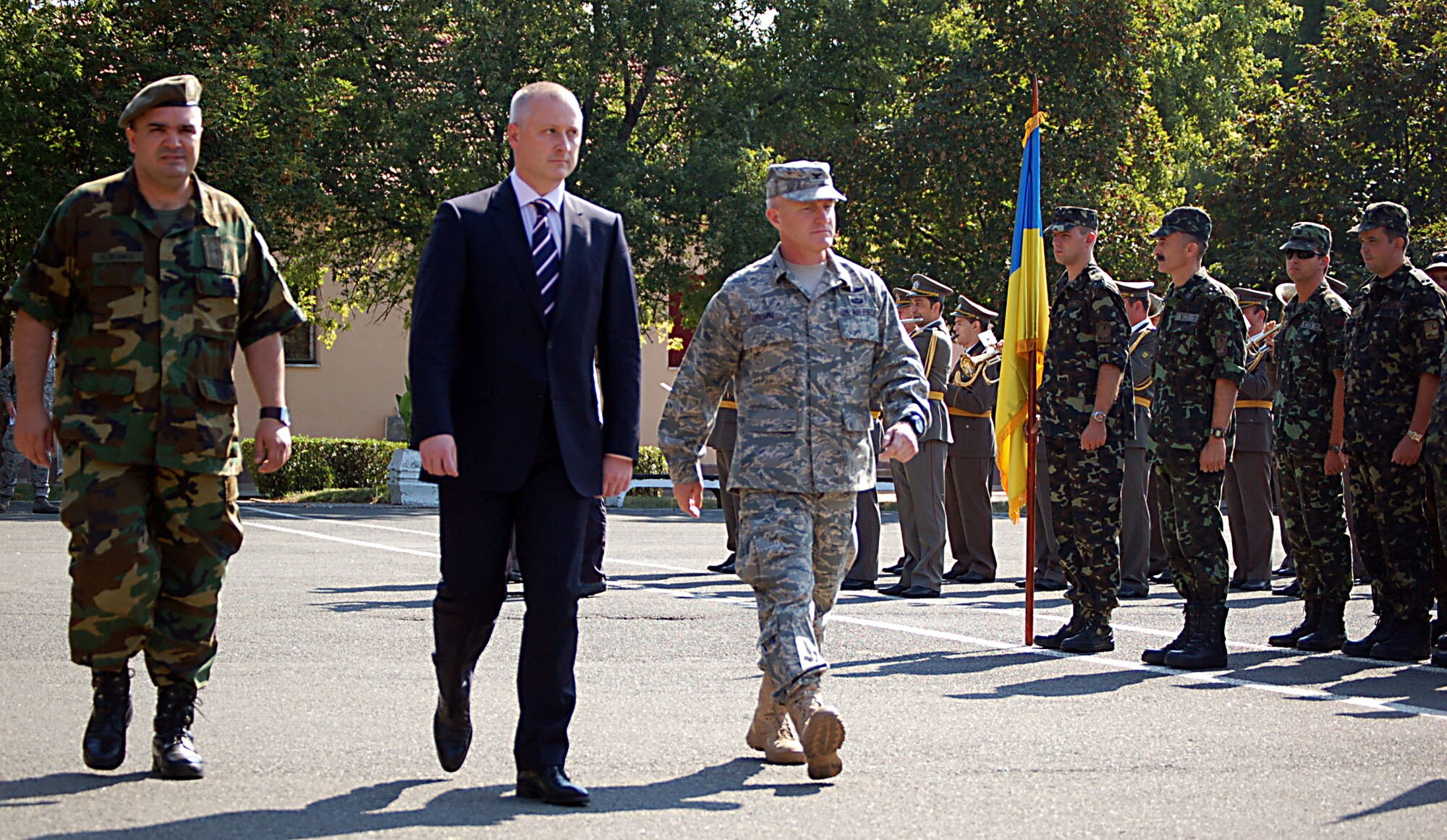 NIS, Serbia – From left: Lt. Col. Goran Desancic, Serbian Armed Forces MEDCEUR 2009 co-director; Zoran Vesic, a Serbian state secretary; and Col. Tim Brown, 435th Contingency Response Group commander and U.S. MEDCEUR 2009 co-director, walk past members of the Ukrainian military during the opening ceremony for MEDCEUR 2009, or the military medical training exercise in Central and Eastern Europe. More than 15 nations will participate in the exercise scheduled for Sept. 2-13. (U.S. Air Force photo/Senior Airman Kali L. Gradishar)