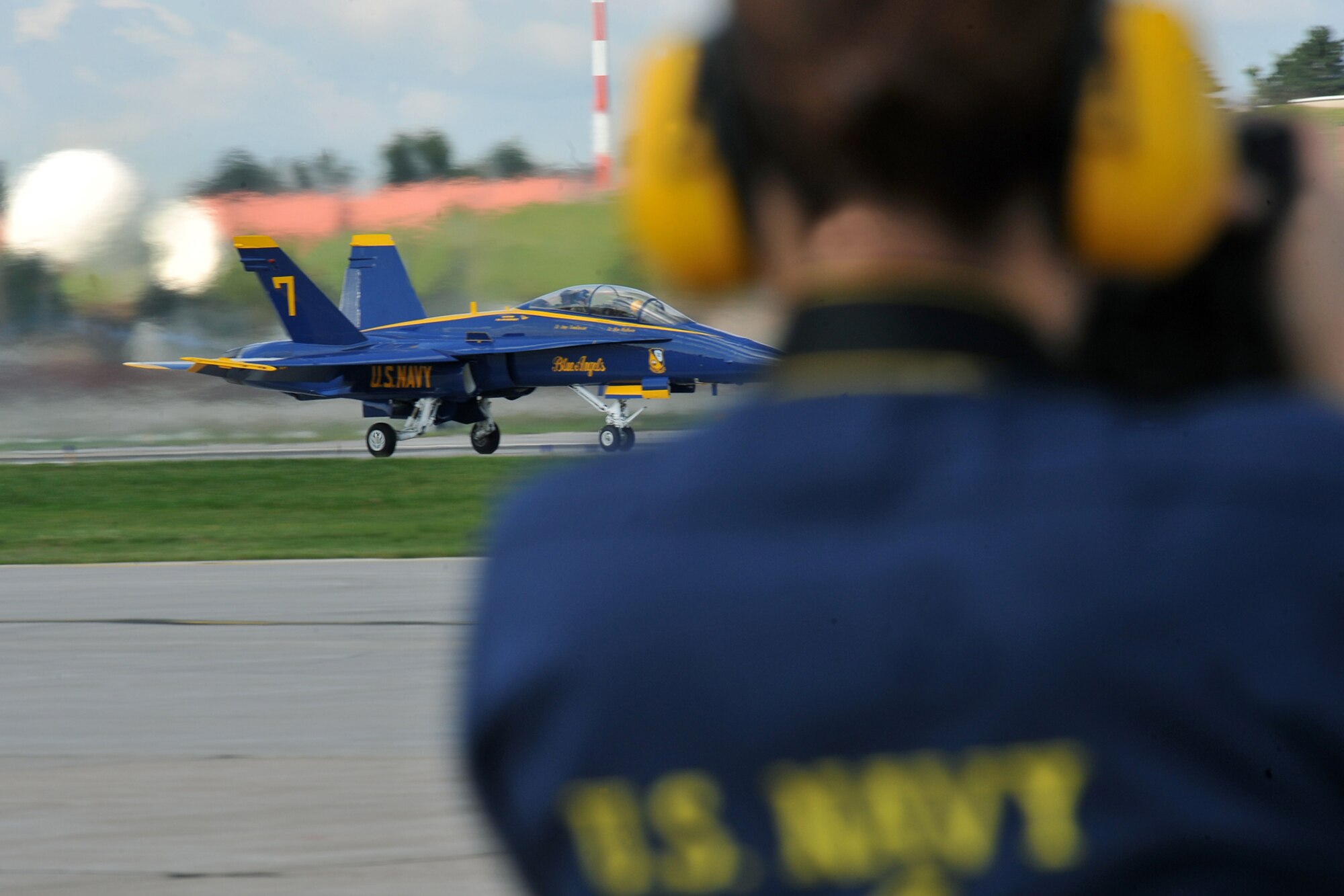 OFFUTT AIR FORCE BASE, Neb., -- Brig. Gen. John N.T. Shanahan, 55th Wing commander and U.S. Navy Lt. Mark Swinger, a Blue Angels pilot, take off in an F-18 Hornet, while Petty Officer 2nd Class Jennifer Blake, the Blue Angels mass communication specialist, photograhs the moment during a Blue Angels demonstration here Aug. 28. U.S. Air Force Photo by Charles Haymond