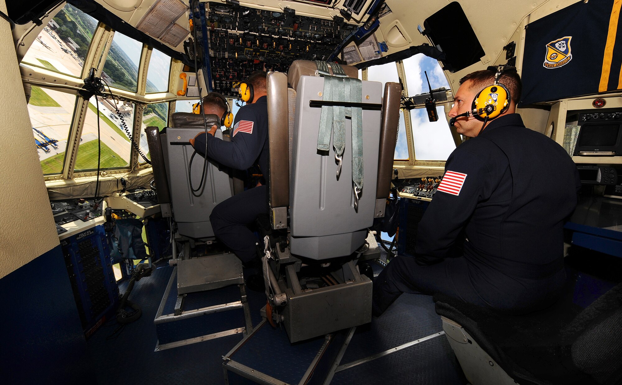 OFFUTT AIR FORCE BASE, Neb. -- Staff Sgt. Joe Alley (right), watches the Offutt runway as the U.S. Navy Blue Angel's modified C-130 "Fat Albert," takes a sharp left turn here Aug. 28. U.S. Air Force Photo by Josh Plueger