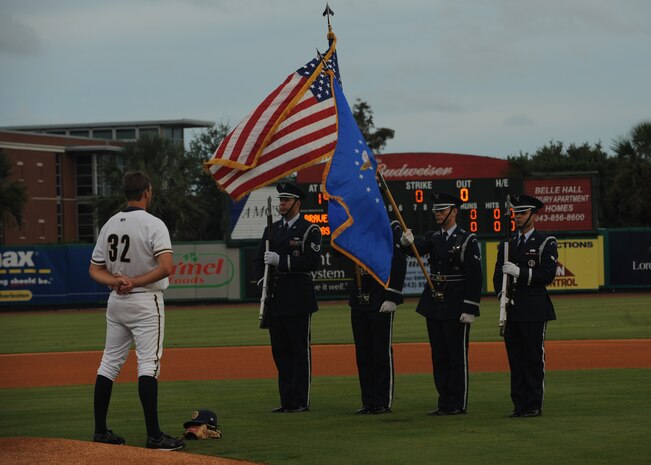 Members of the Charleston AFB honor guard post the colors on the field at Joseph P. Riley Jr. Park before the start of a Charleston RiverDogs baseball game Aug. 26. The base honor guard regularly performs details in the Charleston area demonstrating Air Force patriotism, professionalism and military bearing throughout the community. (U.S. Air Force photo/Senior Airman Katie Gieratz)