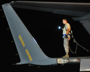 Staff Sgt. Dustin Clark performs a combined pre-flight inspection on the right wing of a C-17 on the flightline here Aug. 27. The steps of the inspection are detailed within three separate books, divided into sections of instructions covering the inside, top, wing and the left and right exterior areas. Sergeant Clark is a crew chief with the 315th Aircraft Maintenance Squadron. (U.S. Air Force photo/Staff Sgt. Daniel Bowles)