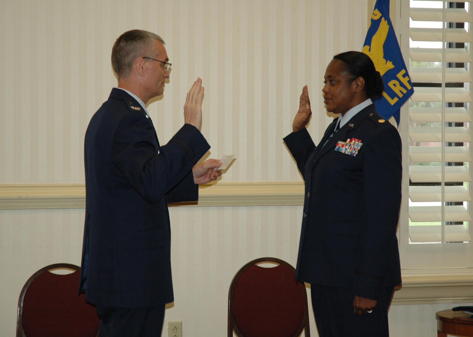 Colonel Steven Chapman, 315th Airlift Wing commander, Charleston Air Force Base, S.C., administers the oath of office to Lt. Col. Donna McNabb-Riley on Sept. 1, 2009.  Colonel McNabb-Riley is one of twenty-two 315 AW members selected for promotion to Lieutenant Colonel.  (Air Force photo / Tanya Koch)